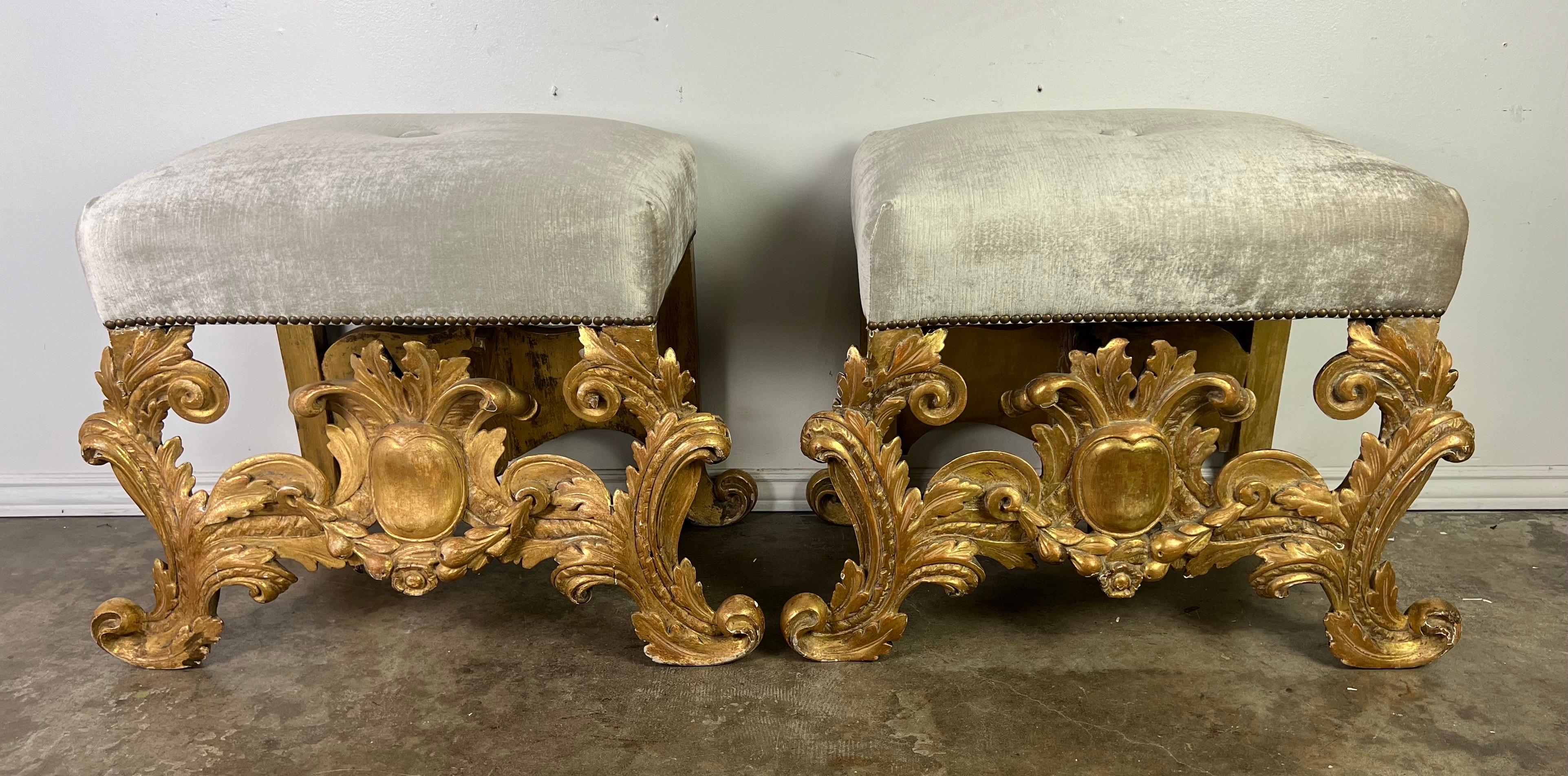Italian Baroque style benches, each radiating the opulence and grandeur of the period.  These benches are a testament to the lavish aesthetics of the Baroque ers, with their gilt wood frames finished in 22-carat gold leaf that glistens under the