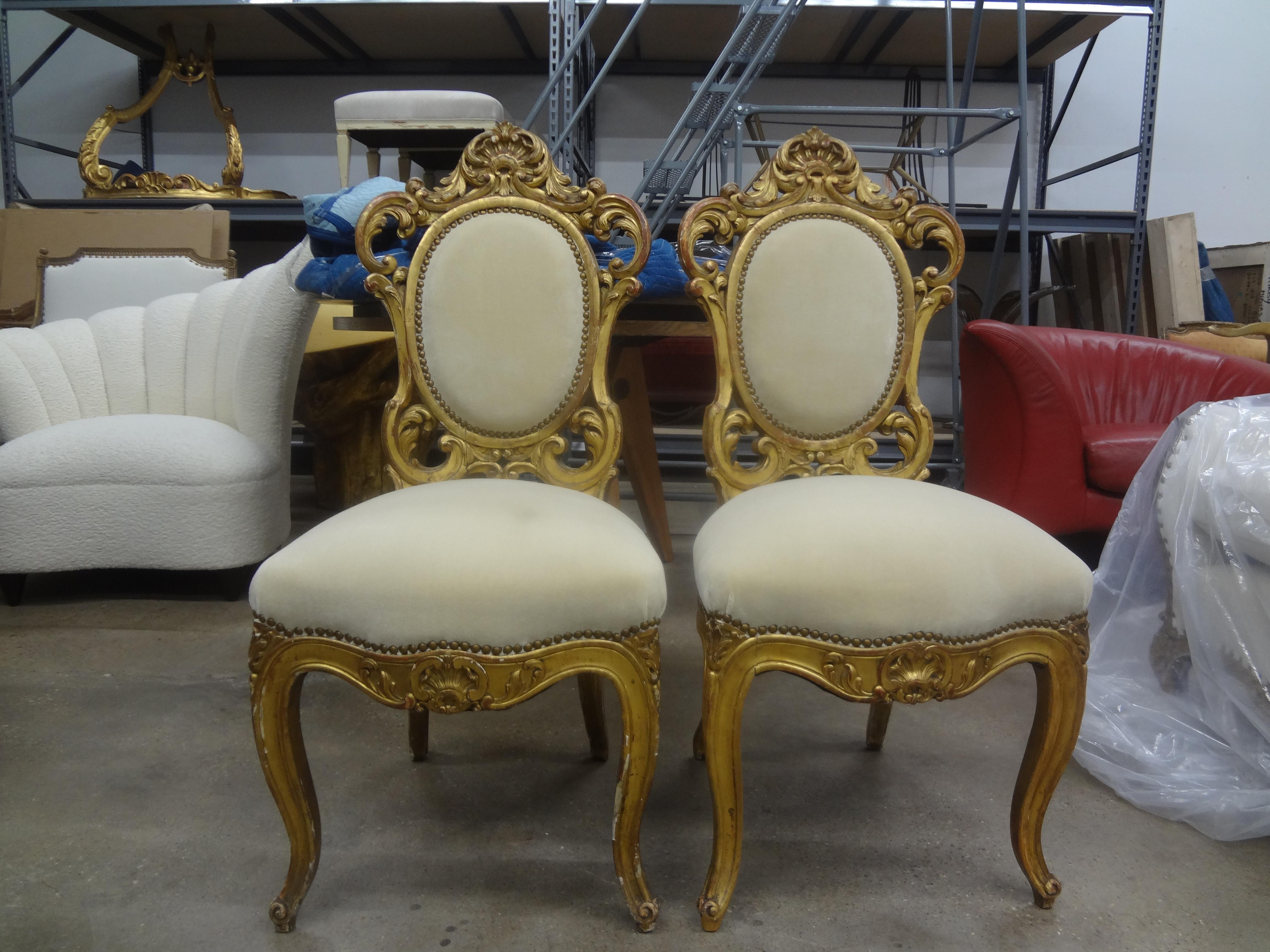 Pair of Italian Baroque style giltwood chairs.
Stunning pair of Roman Baroque style gilt wood chairs, circa 1920. These unusual chairs or side chairs have been recently upholstered in camel colored mohair with brass nail head detail.
Perfect