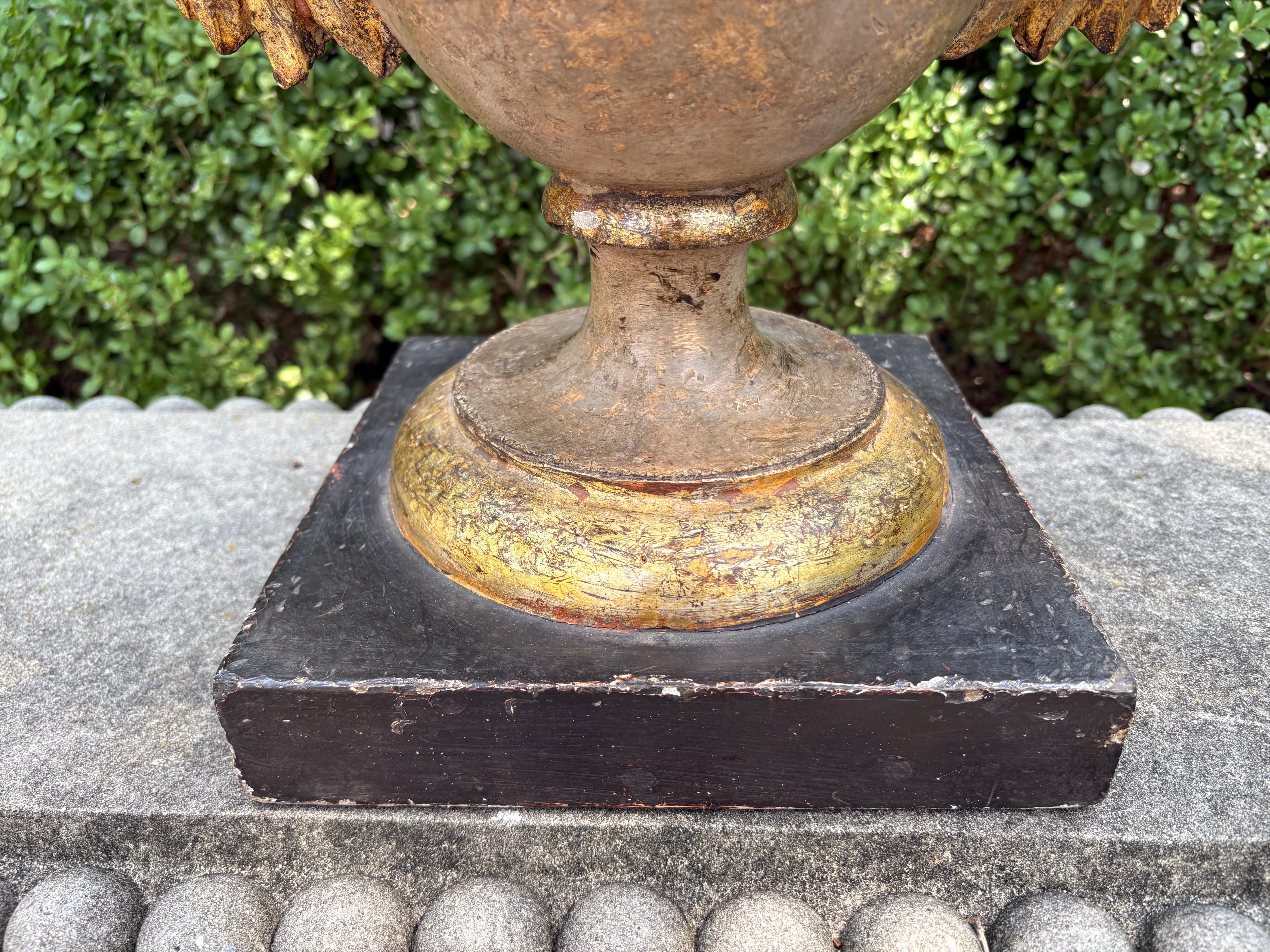 Pair of Italian Baroque Style Giltwood Urns
Stunning pair of 18th century Italian Neoclassical style or Baroque style gilt wood urns with handles.  These chic urns are from the Tuscany region of Italy and are beautiful as decorative urns or