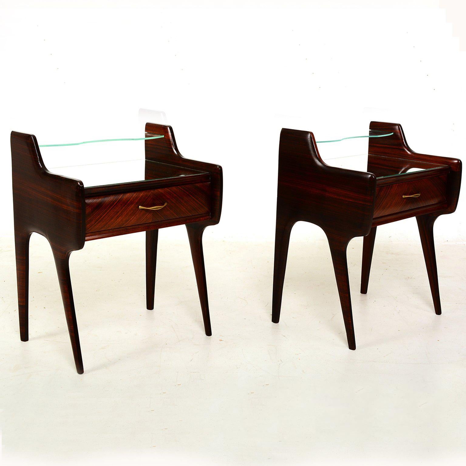 For your consideration a pair of bedside table constructed with rosewood and walnut veneer. Solid bras pull handles, floating glass top with mirror top. 

No stamps or markings from the maker.