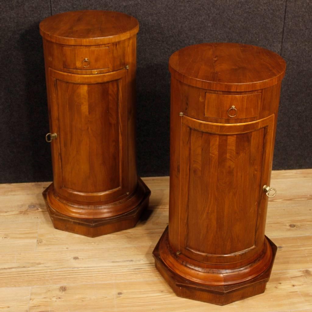 Pair of Italian bedside tables from the 20th century. Furniture carved in cherry and fruitwood of beautiful line and pleasant decor. Bedside tables with a door and a drawer of good capacity and service. Wooden top in character and octagonal base.