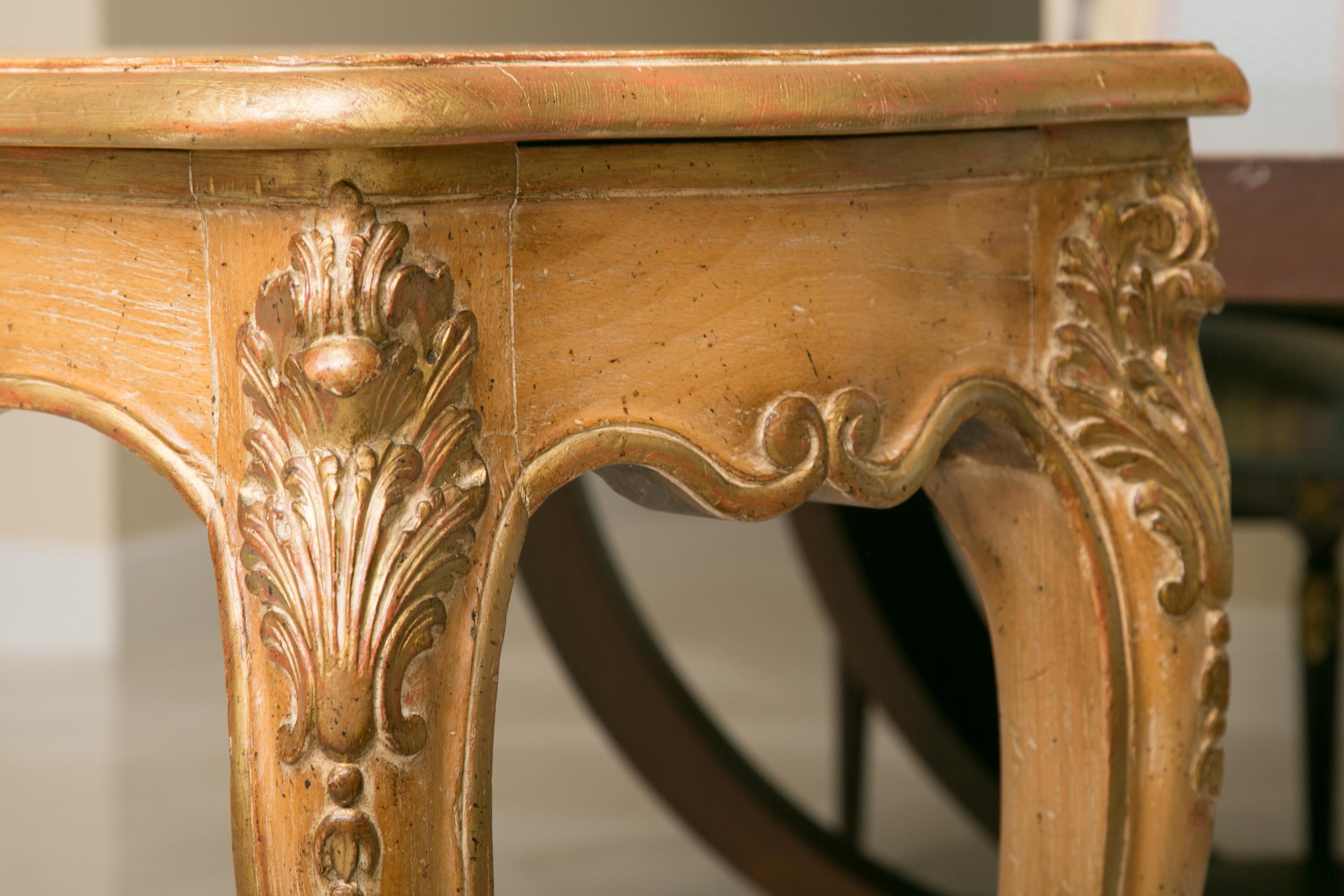 This is a hand carved Italian beechwood console table. A plank top with a beveled edge rests over a bold shaped frieze carved with ornamental flourishes. Raised on long, slender cabriole legs, 20th century. Only one available.