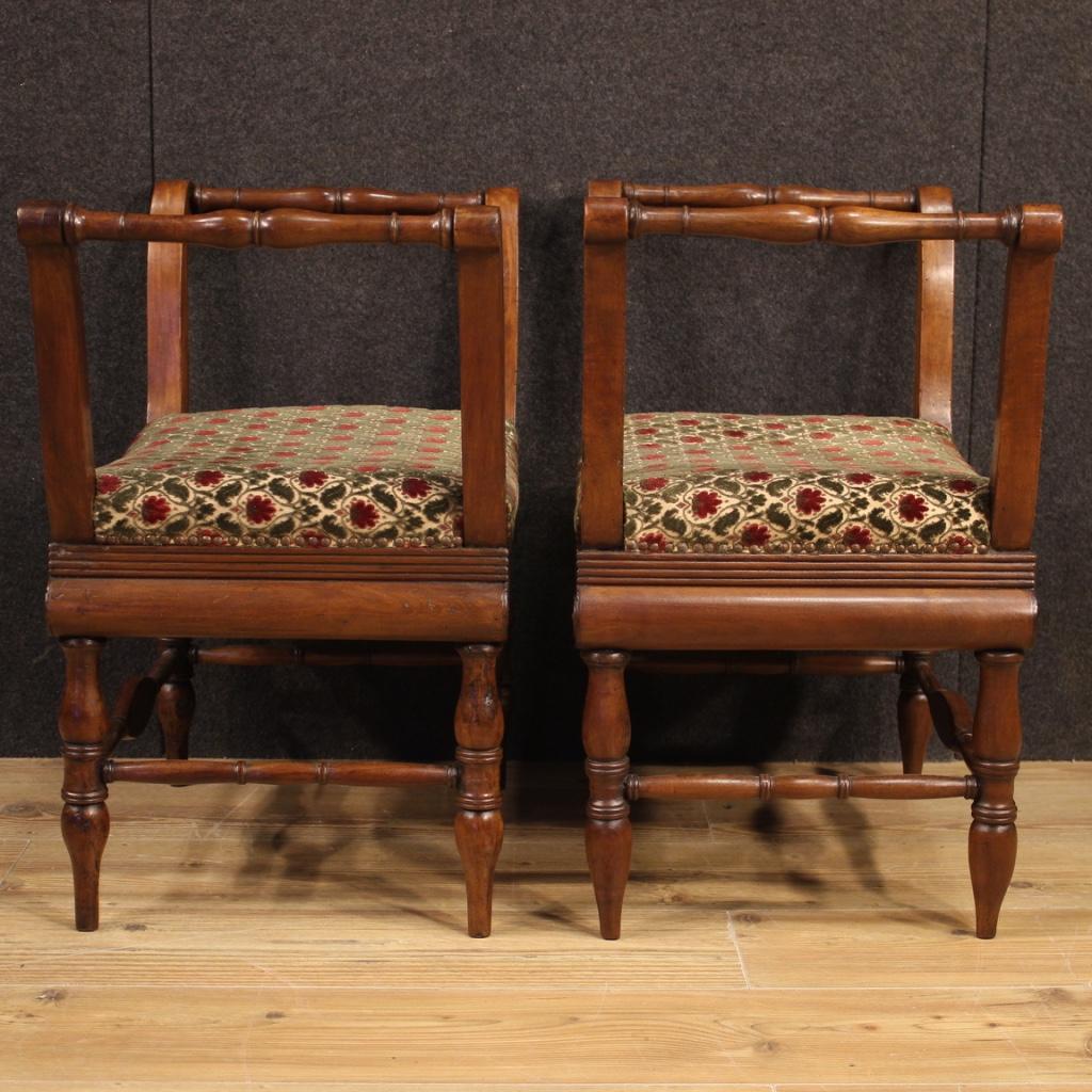 Pair of Italian benches from the Charles X era. Furniture carved in walnut wood with seats upholstered in fabric with floral decorations (not original, replaced during the 20th century). Benches of beautiful line and pleasant furnishings, finely