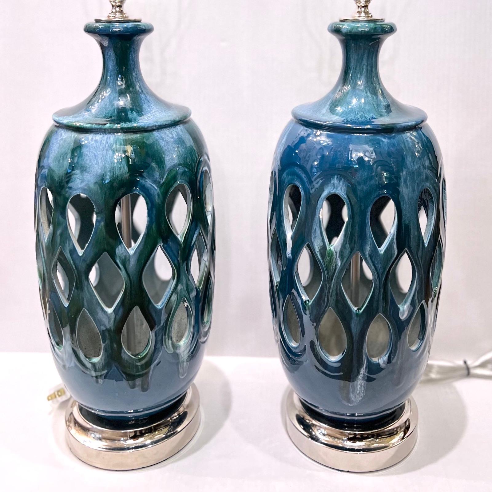 A pair of circa 1960s Italian pierced blue porcelain lamps with silver bases.

Measurements:
Height of body: 19.25