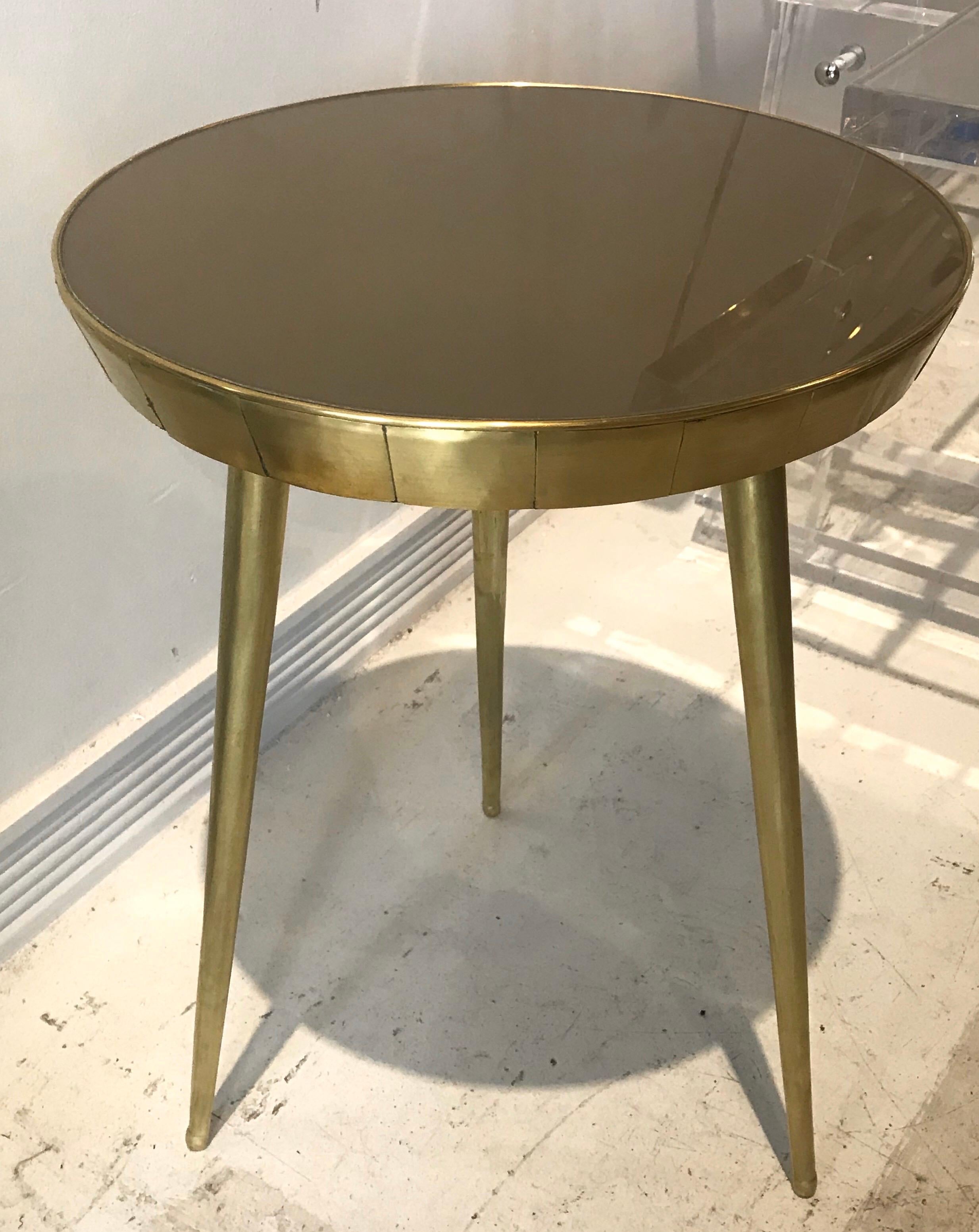 A pair of chic reverse painted (taupe colored) glass and brass Italian side tables.