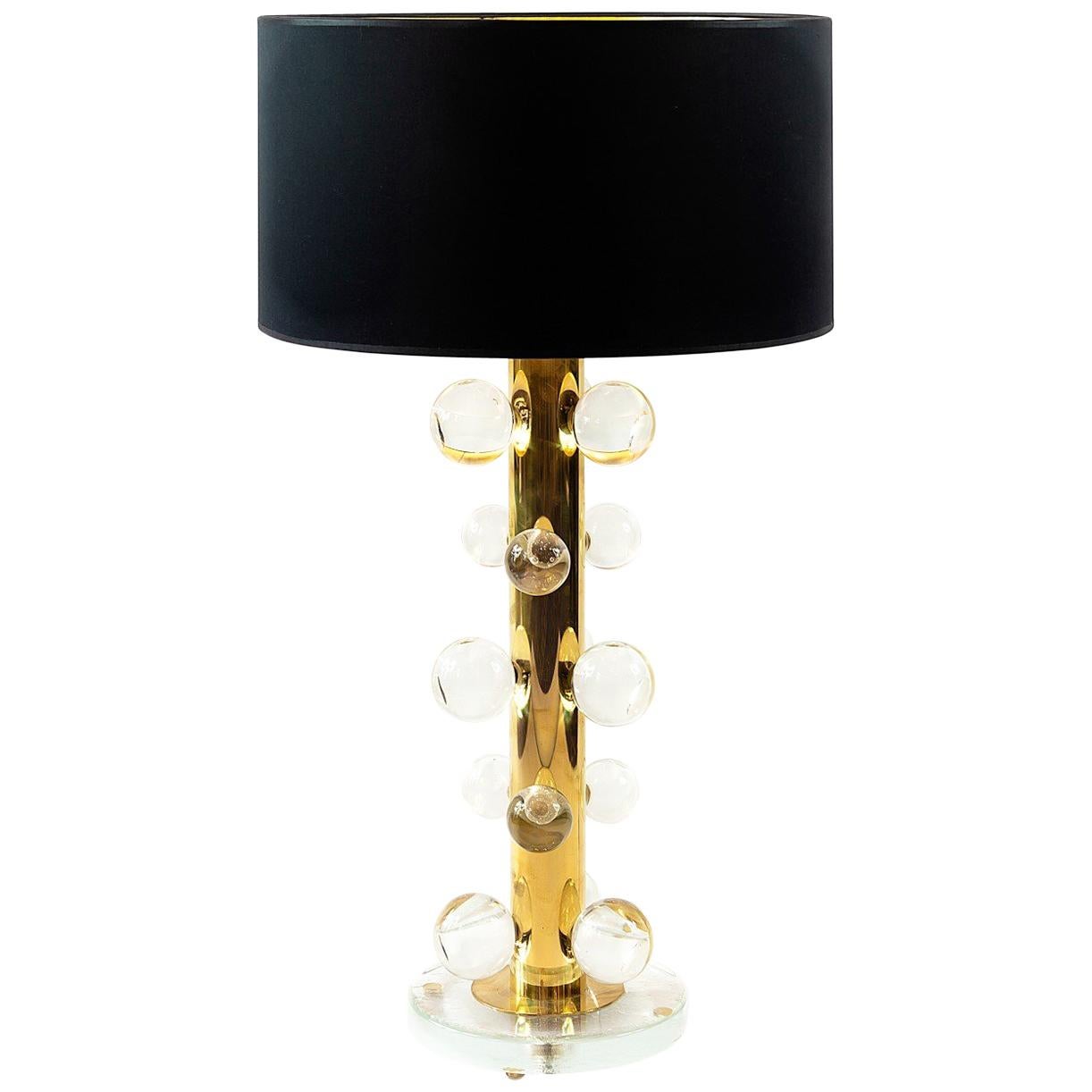 This pair of Italian table lamps are designed in solid brass and glass base.
They are decorated with transparent Murano glass details. 
New made satin finish black color textile shades are with gold inside.
Each lamp is heavy and solid.

 