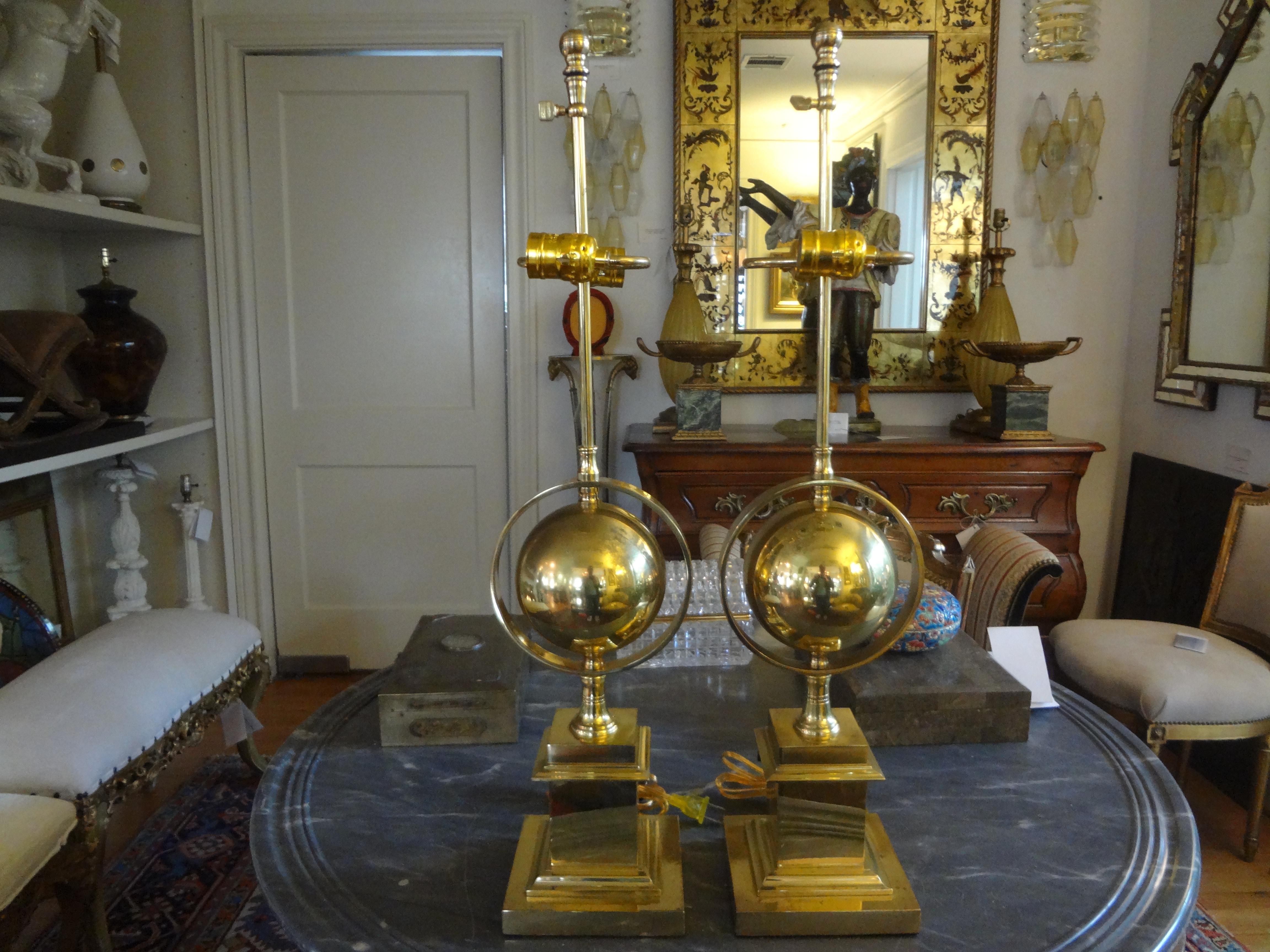 Great pair of midcentury Italian brass armillary lamps. These stunning vintage Hollywood Regency style Italian brass lamps have been newly wired for The U.S. Market with dual sockets and new inline switches.