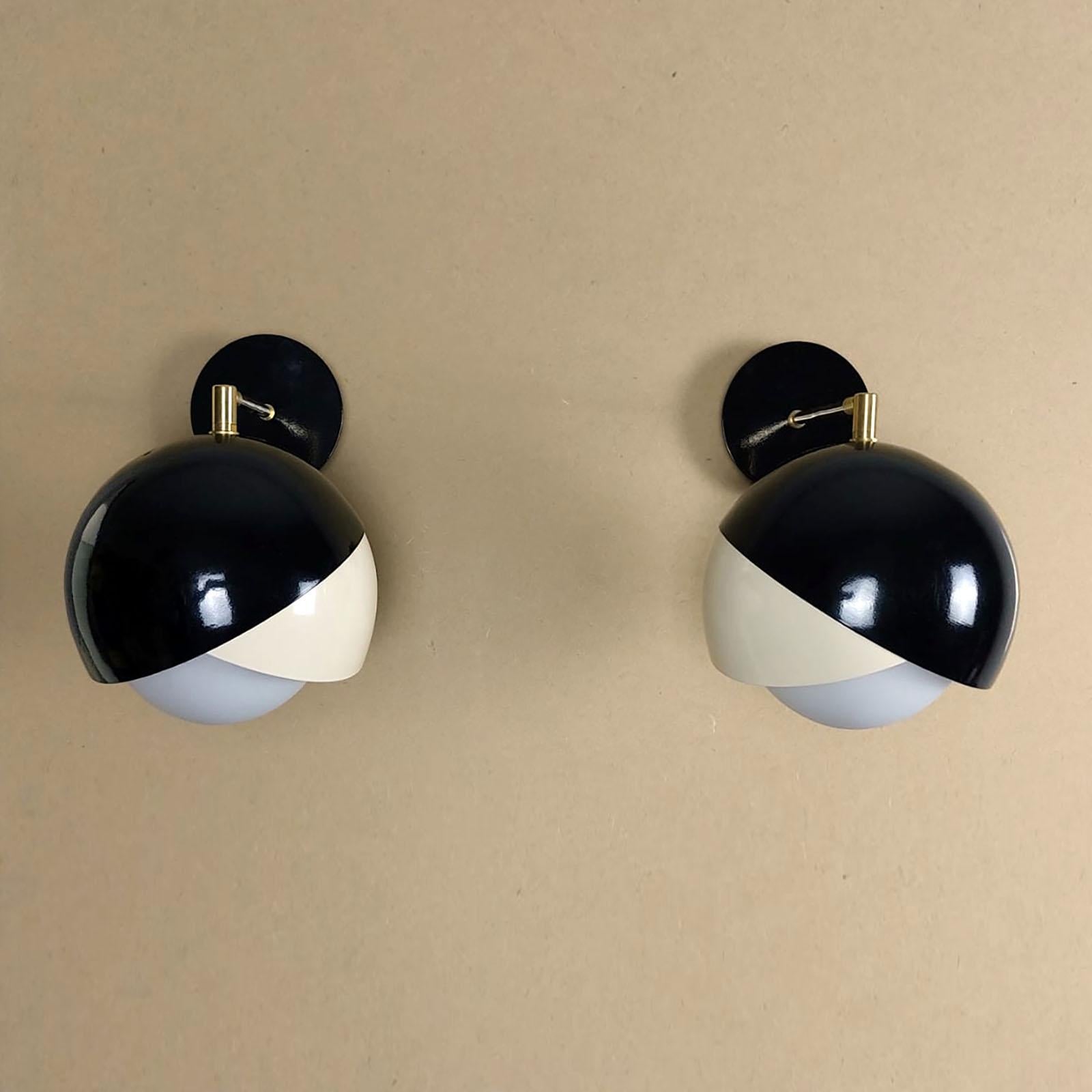Lovely pair of adjustable wall lights, in light ivory and black lacquer, shaped as stylized blossom, with a round satined glass globe in the middle, covering the light base.
E14 light base for a max 60W bulb, on request we can replace it with E12