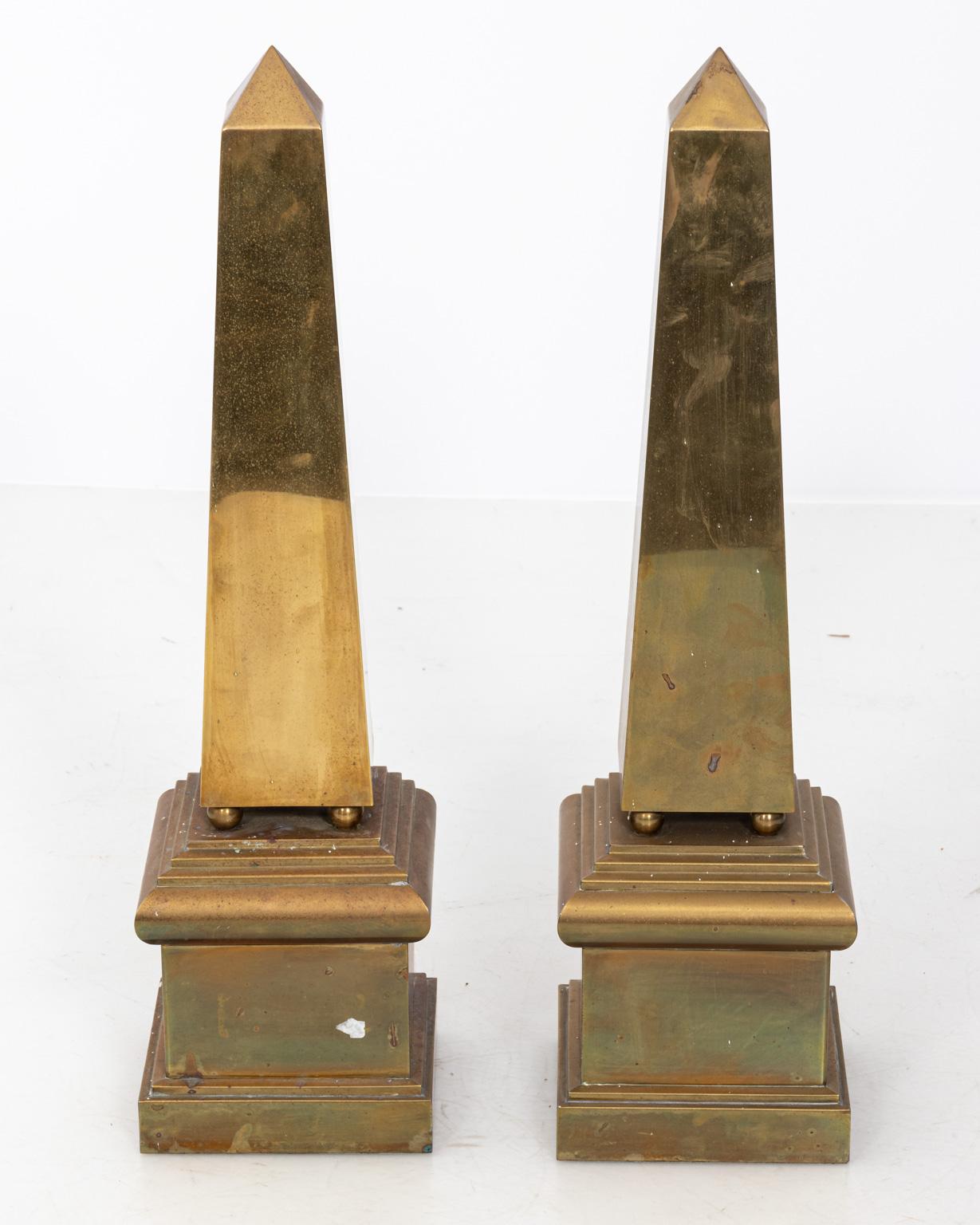 Pair of polished Italian brass tabletop obelisks on plinths. Please note of wear consistent with age including oxidation and original patina.