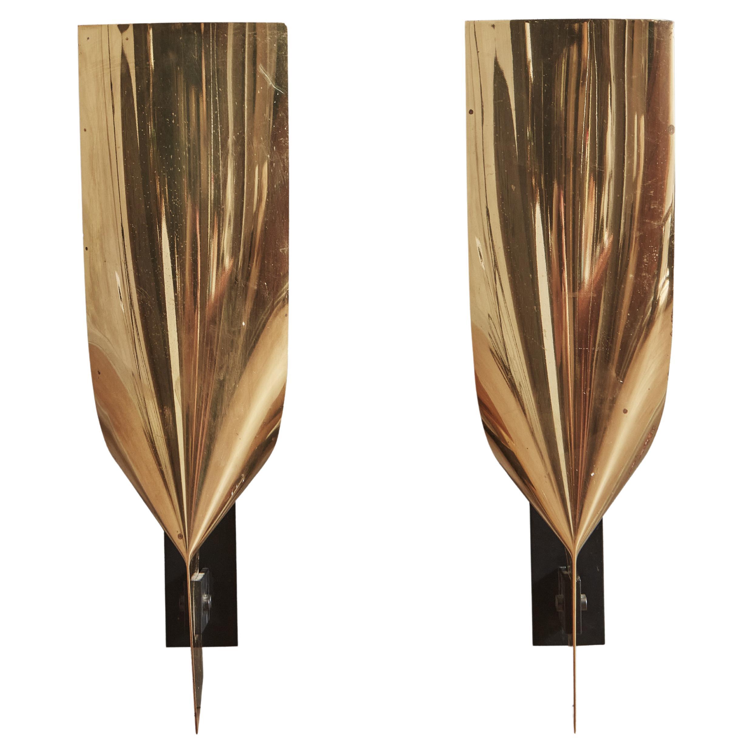 A pair of 1960’s brass wall sconces by Tobias Fraum. Created through the marriage of laquered metal base and brass folded sheet, it follows a tipical mid-century metal processing technique: calendering, a metal bending technique often used to create