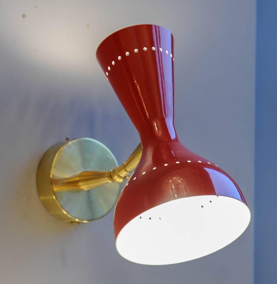 Pair of Italian wall sconces made of brass and an adjustable bright red enameled metal cone with two lights.
 