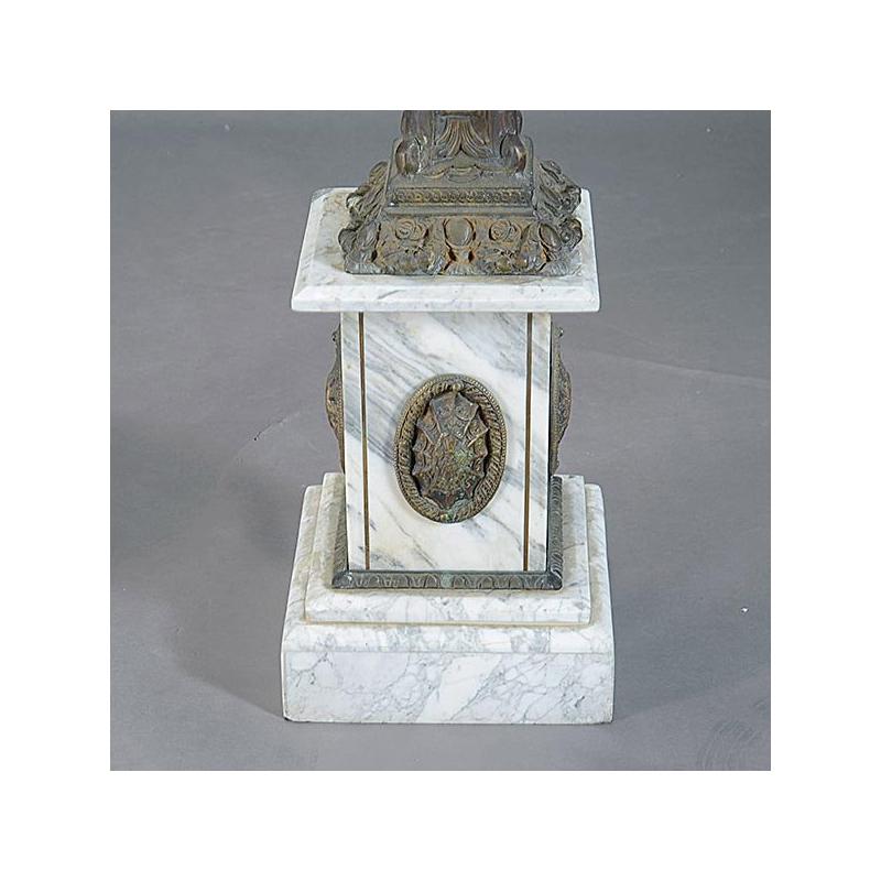 Unique pair of Italian neoclassical style bronze and white marble pedestals. 
Moulded white marble top over acanthus decorated bronze support with foliage swags and scrolls, over stepped marble base mounted with bronze medallions. 

Very highly