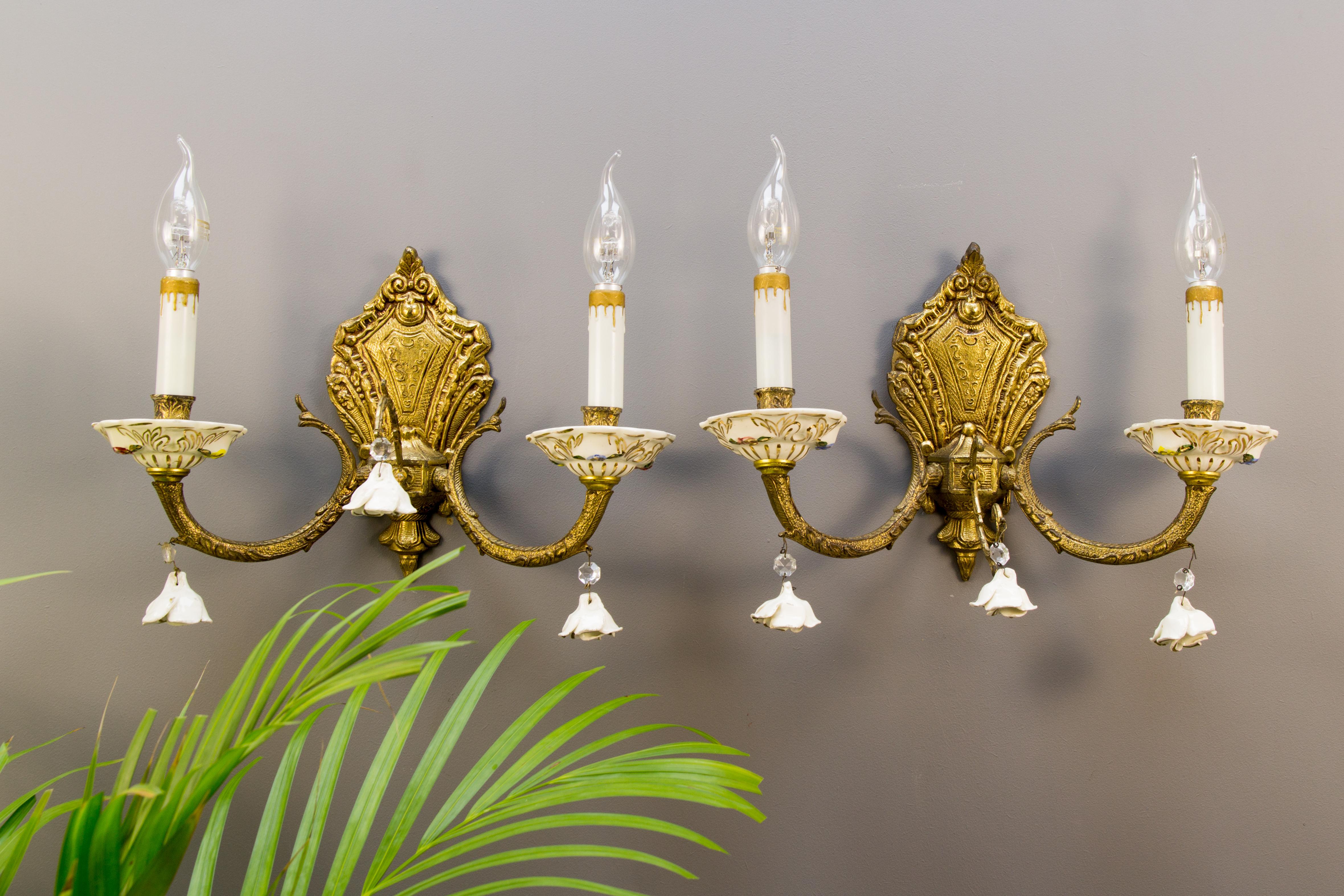 Pair of Italian bronze sconces decorated with porcelain roses and porcelain bobeches. Each arm has a socket for E14 light bulb.
Dimensions (each sconce without light bulbs):
Measures: Height 27 cm / 10.62 in; width 37 cm / 14.56 in; depth 11 cm /