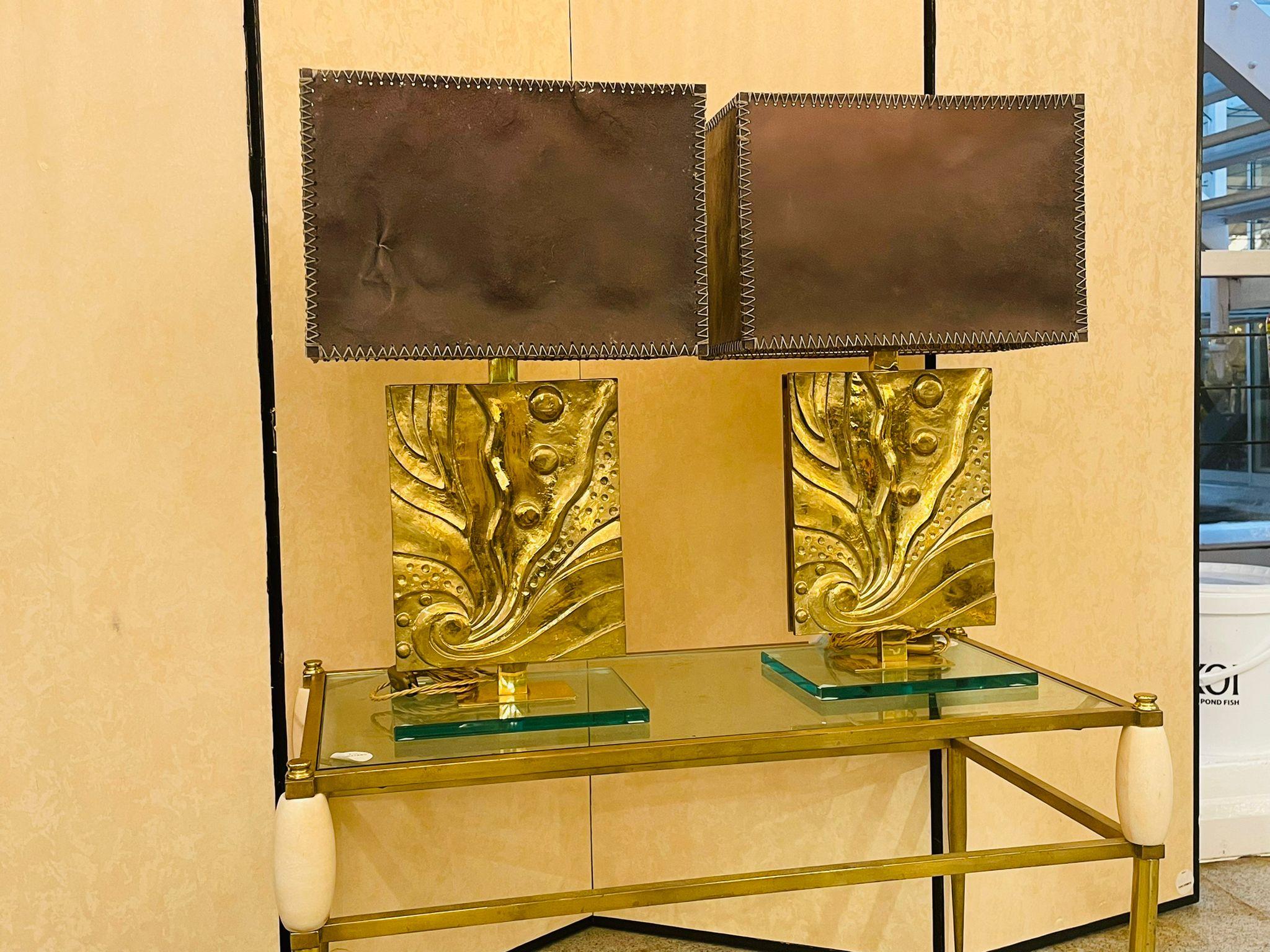 Pair of table lamps with a rectangular glass base, brass structure and cast bronze facades showing a Horn of plenty.