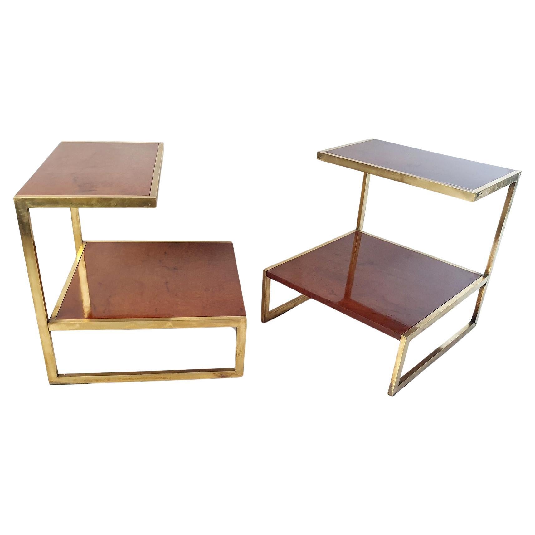 An elegant pair of Italian vintage side tables in brass and burl in the manner of Willy Rizzo Italy. Will work as end tables or bedside tables. The tables has solid frames in brass with inlaid burl shelves on both levels. 