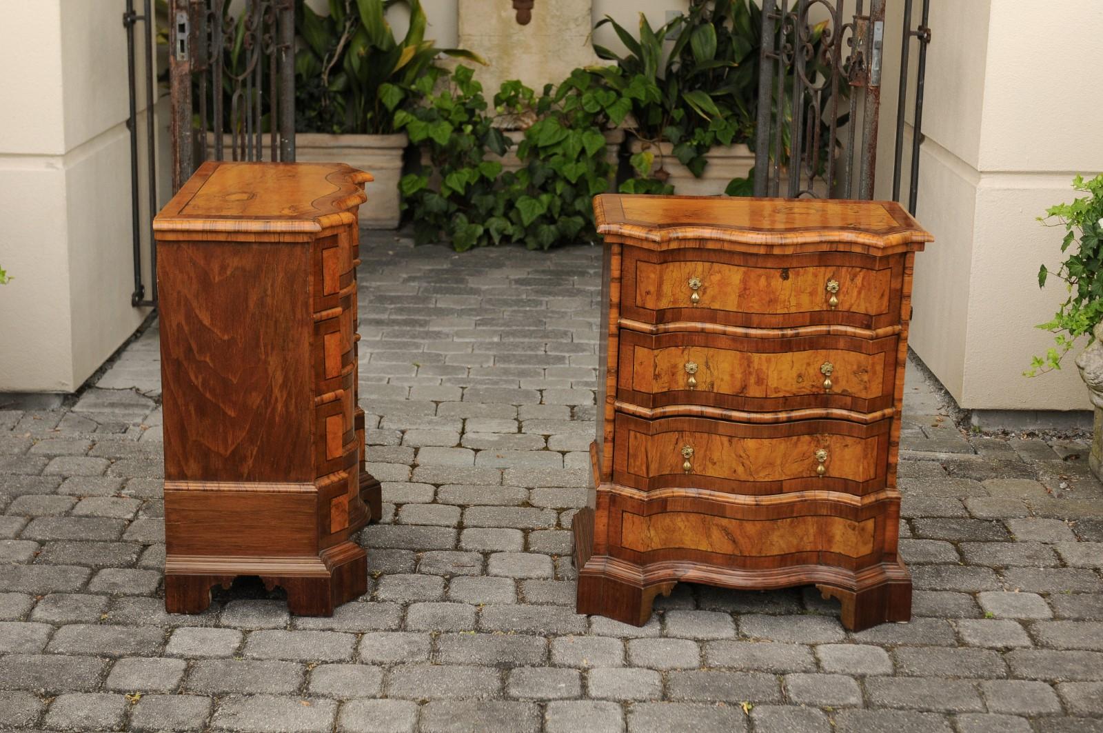 A pair of Italian small burl walnut commodes from the late 19th century, with serpentine front and banding. Born in Italy during the last decade of the 19th century, each of this pair of small commodes features an exquisite top, adorned with burl