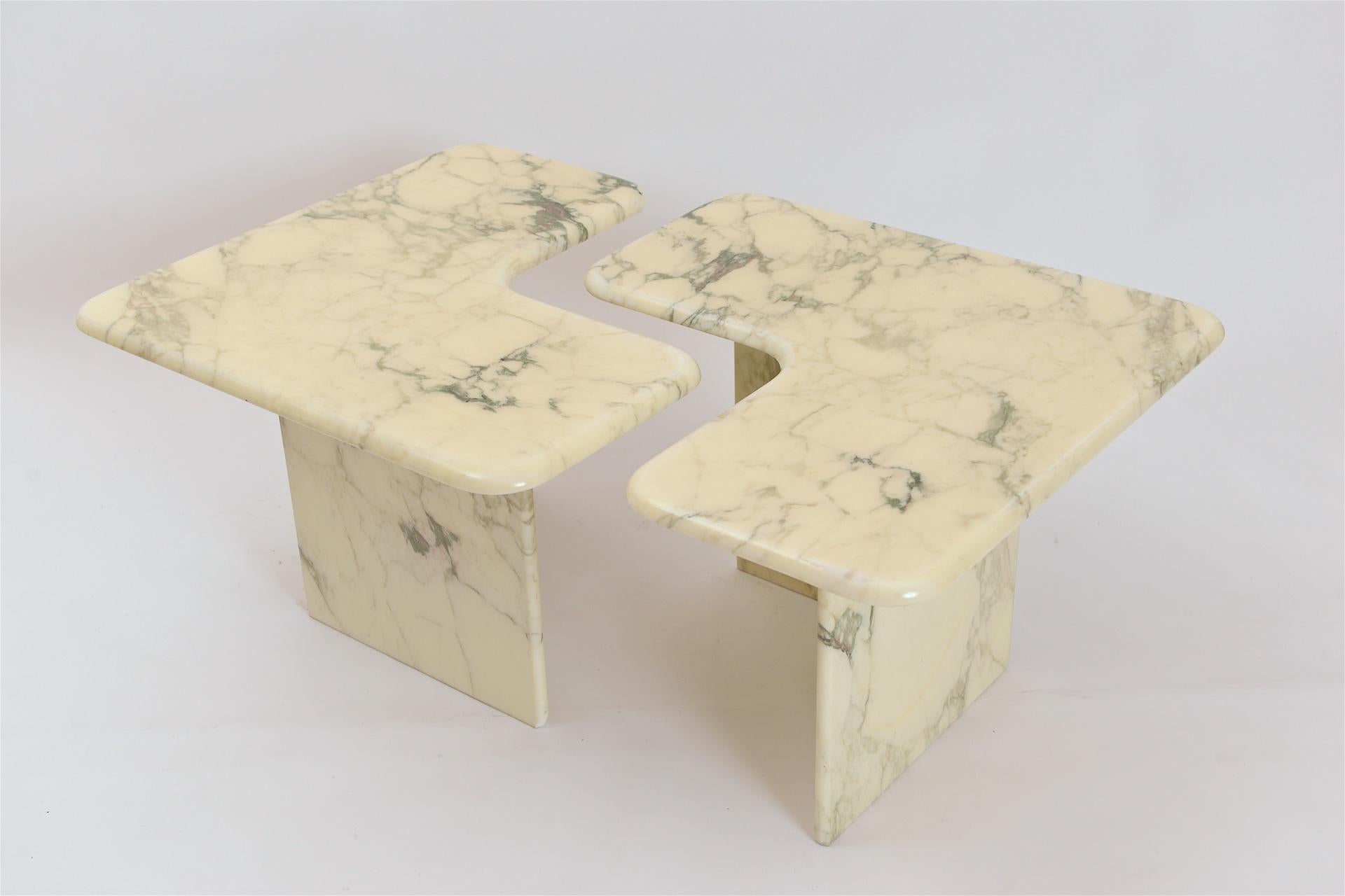 An extremely versatile pair of corner tables in a gorgeous off-white and grey/green color Calacatta marble. Manufactured in the 1980s, these tables can be positioned together, in a rectangular formation with an ‘s’ shaped gap, or separately,