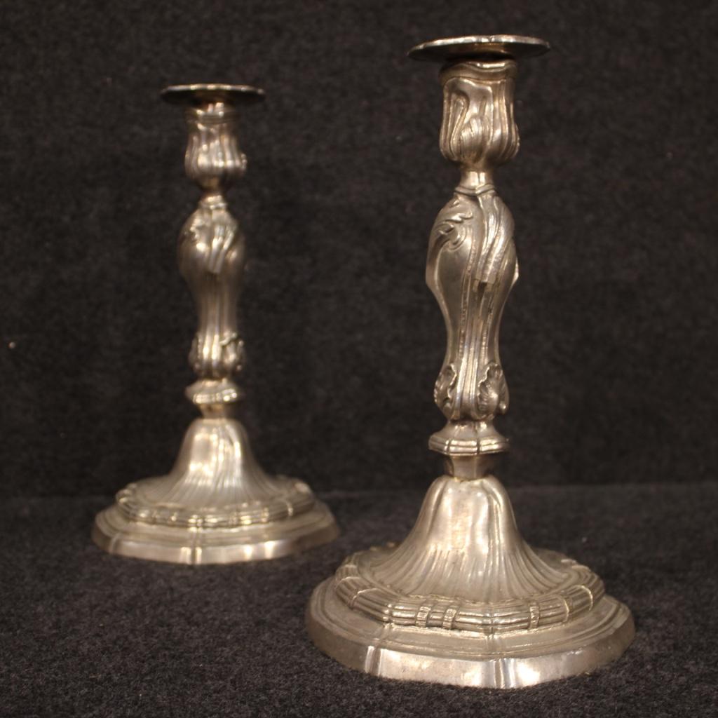 Pair of Italian candleholders from the mid-20th century. Objects finely chiselled in silver metal, beautifully decorated. Candelabra single flame complete with removable wax-saving metal saucers (see photo). Central body screwed to the base. They