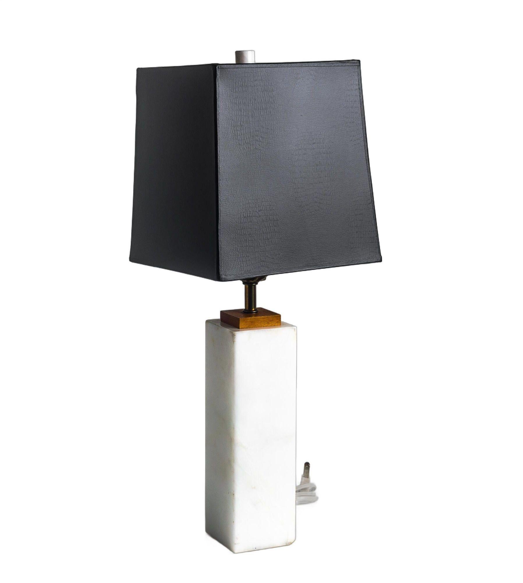Pair of Italian Carrera Marble Square Bedside Lamps Nessen Style 1960's
This elegant pair of bedside lamps showcases exquisite Italian Carrera marble combined with a teakwood top and matching marble finials. The lamps feature solid marble