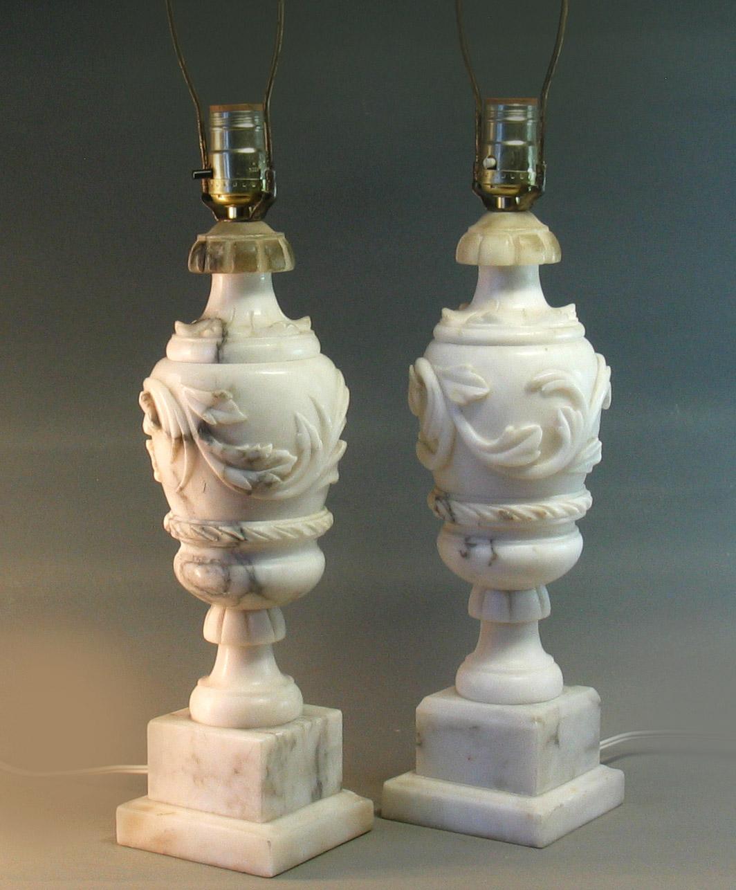 A pair of Italian carved Alabaster table lamps
First half of the 20th century

Of classical urn-form, carved with acanthus, on a square base

Lamps total height: 22 1/2 in.(57.1 cm.) high.
Alabaster urns only: 14 1/4 in.(36.2 cm.)
Base: 4 1/4