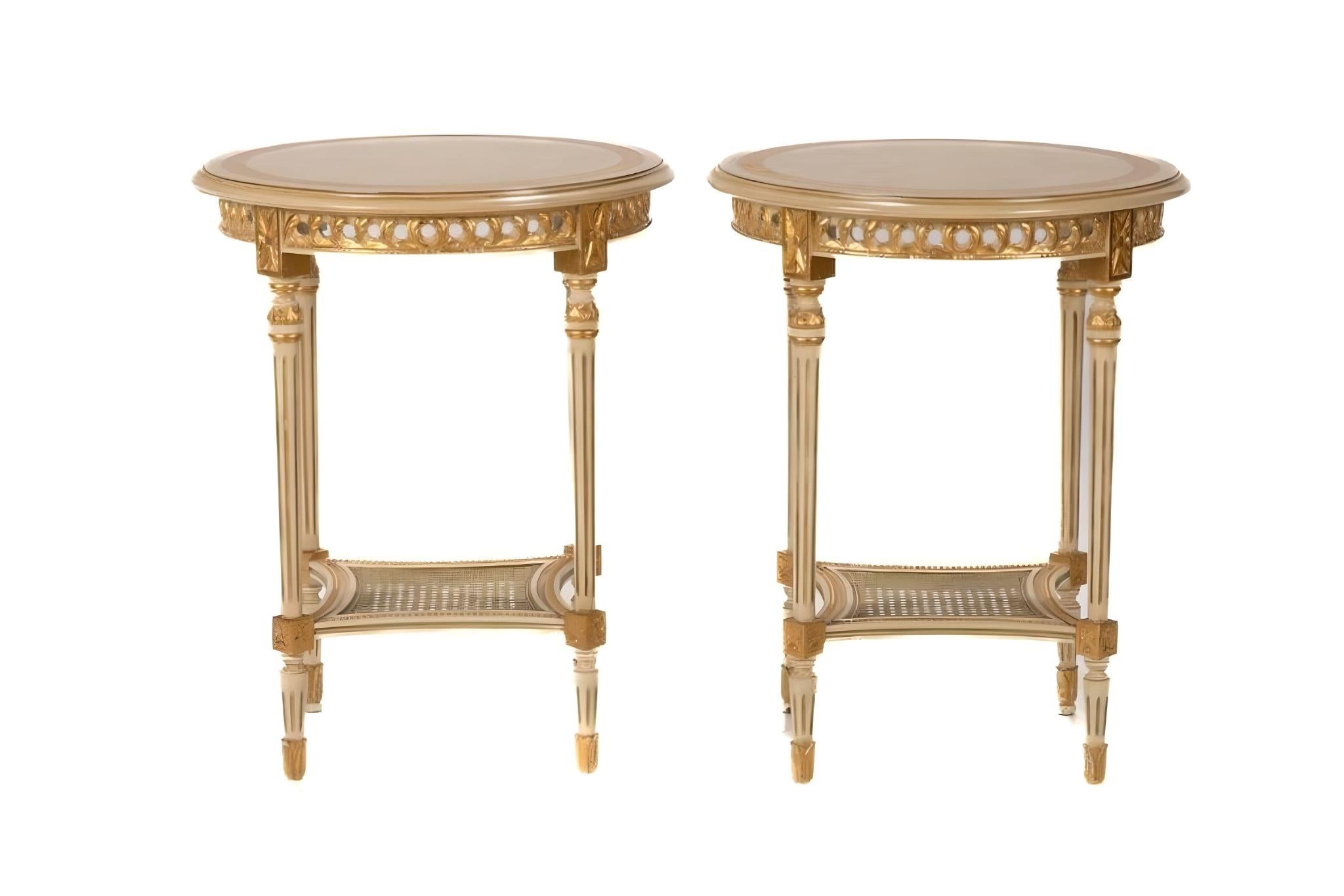 A pair of Italian circular side tables painted in white with gilded accents. Tables in good condition with little marks consistent with age.

Height: 26 1/2