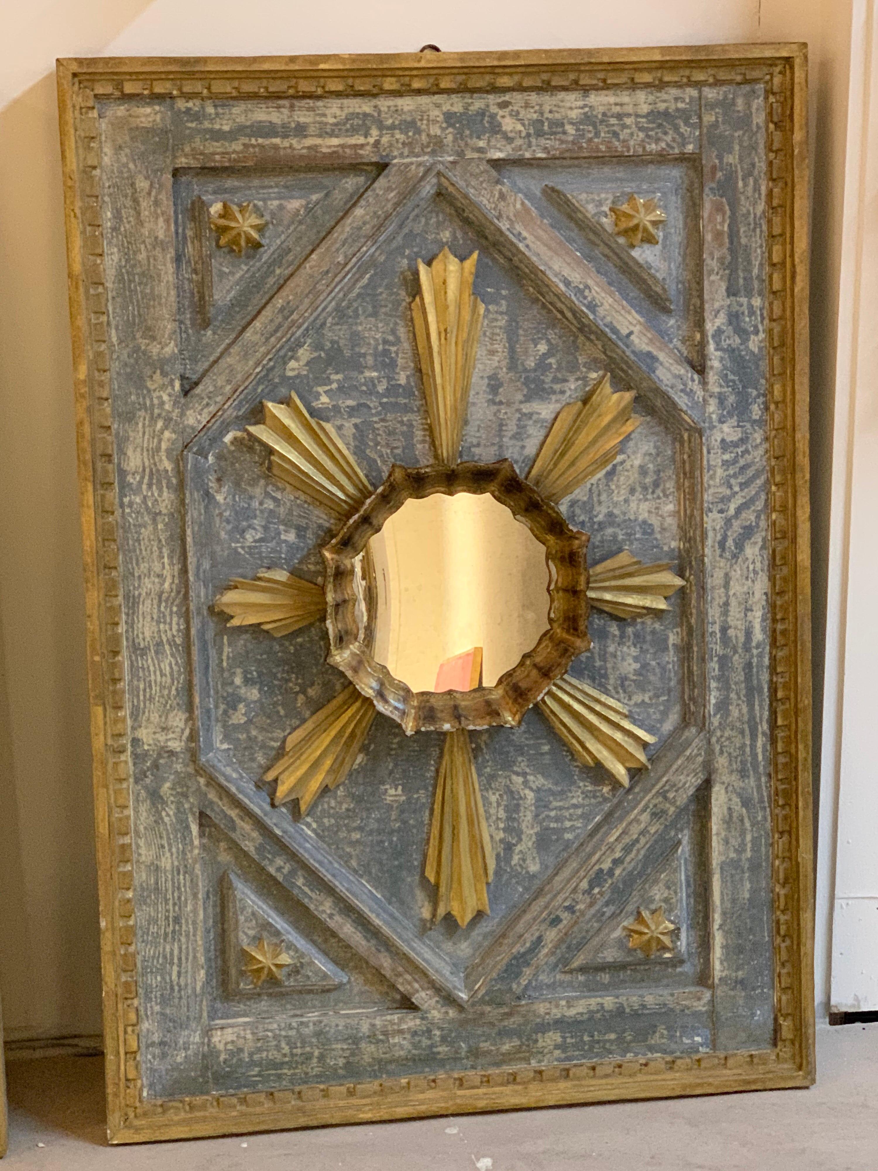 Decorative pair of Italian carved and parcel gilt panels with starburst pattern and mirrors in the center. Very fine patina on these. A beautiful pieces of art!