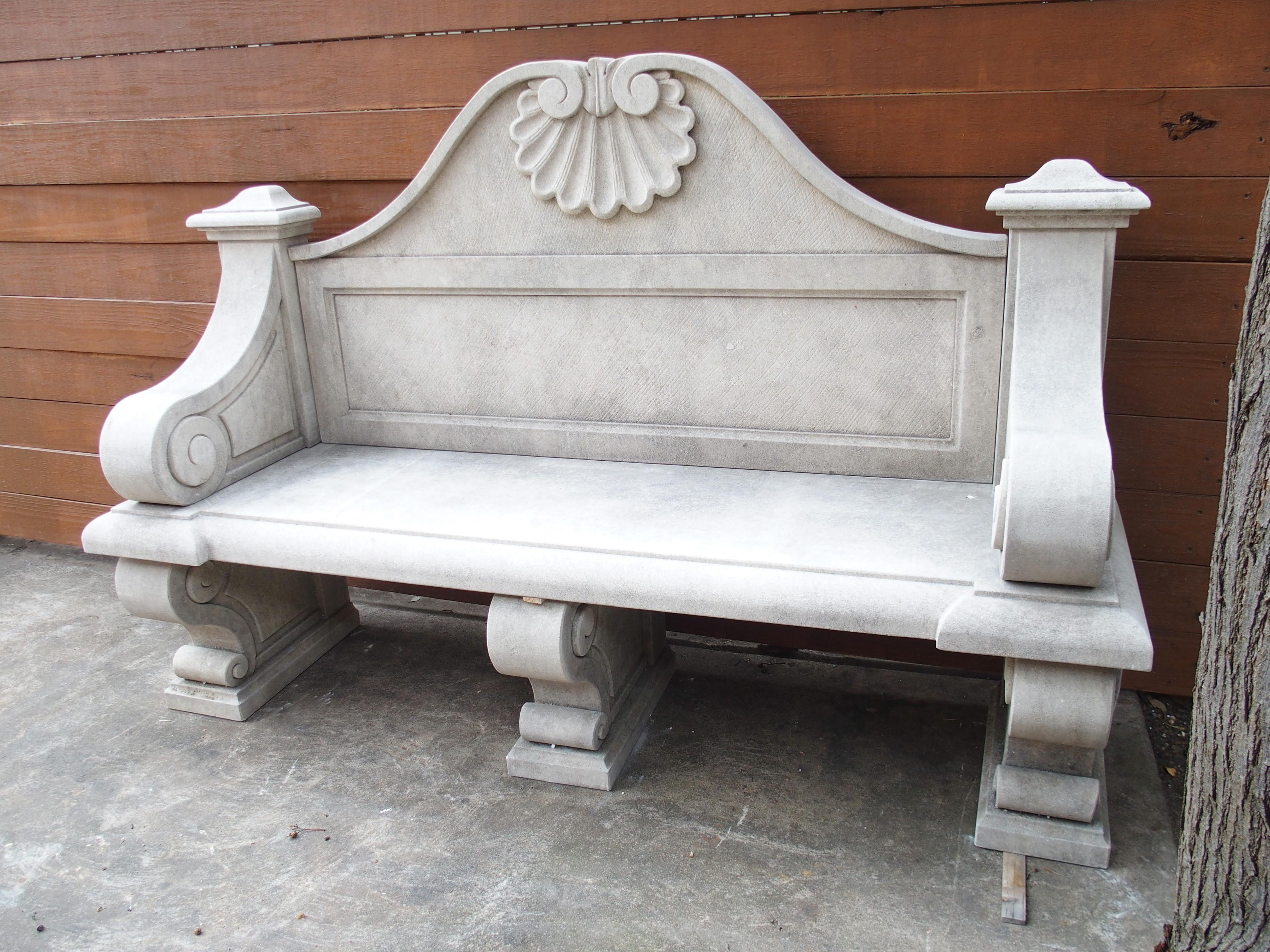 A beautiful pair of Italian garden benches that would make a wonderful addition to an outdoor or interior setting. Both benches are hand-carved from nine pieces of limestone and can seat three adults comfortably. The stone has a light gray hue with