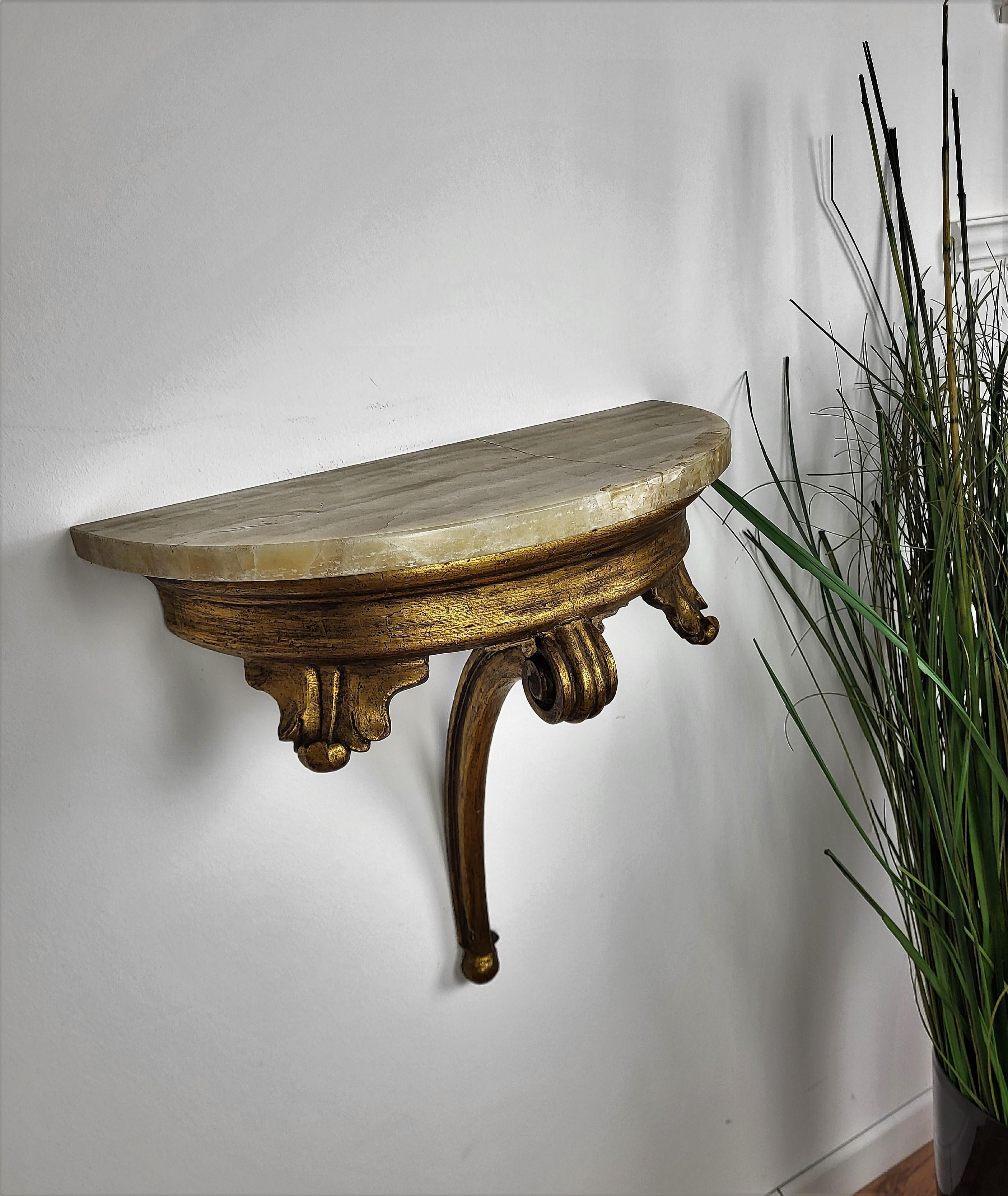 Beautiful pair of Baroque - Rococo style gilt wood demilune marble top wall mounted consoles. Ideal pieces for any interior both in Italian clasic style as well as contrast pieces in modern interiors, they can be used as consoles as well as night
