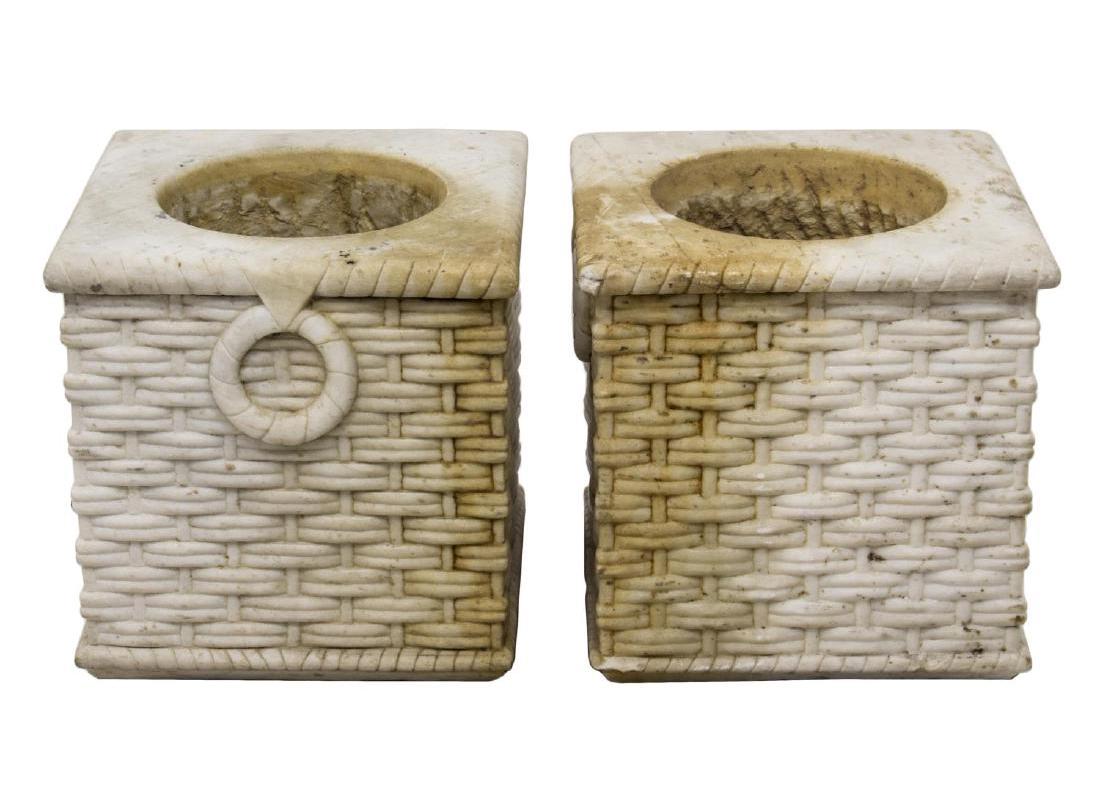 Impressive pair of 19th century Italian neoclassical style finely hand-carved white marble planters in the shape of weaved garden baskets flanked by carved marble ring handles. 

Measures: Inside diameter 10