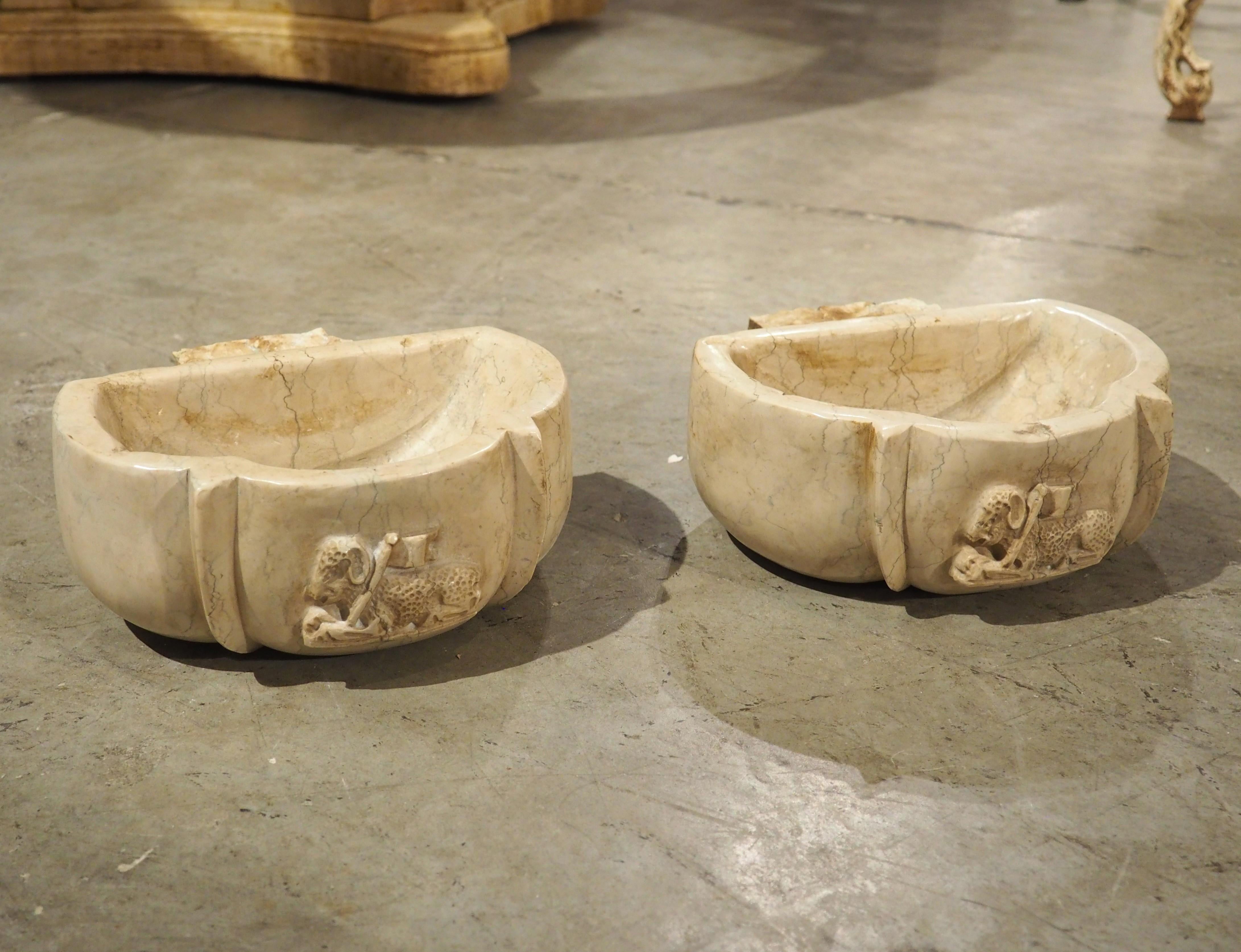 More information coming soon…

A pair of hand-carved Italian marble stoups, with a very pleasing beige hue accented by gray veining.  The front of each stoop has a relief depiction of the Paschal Lamb.