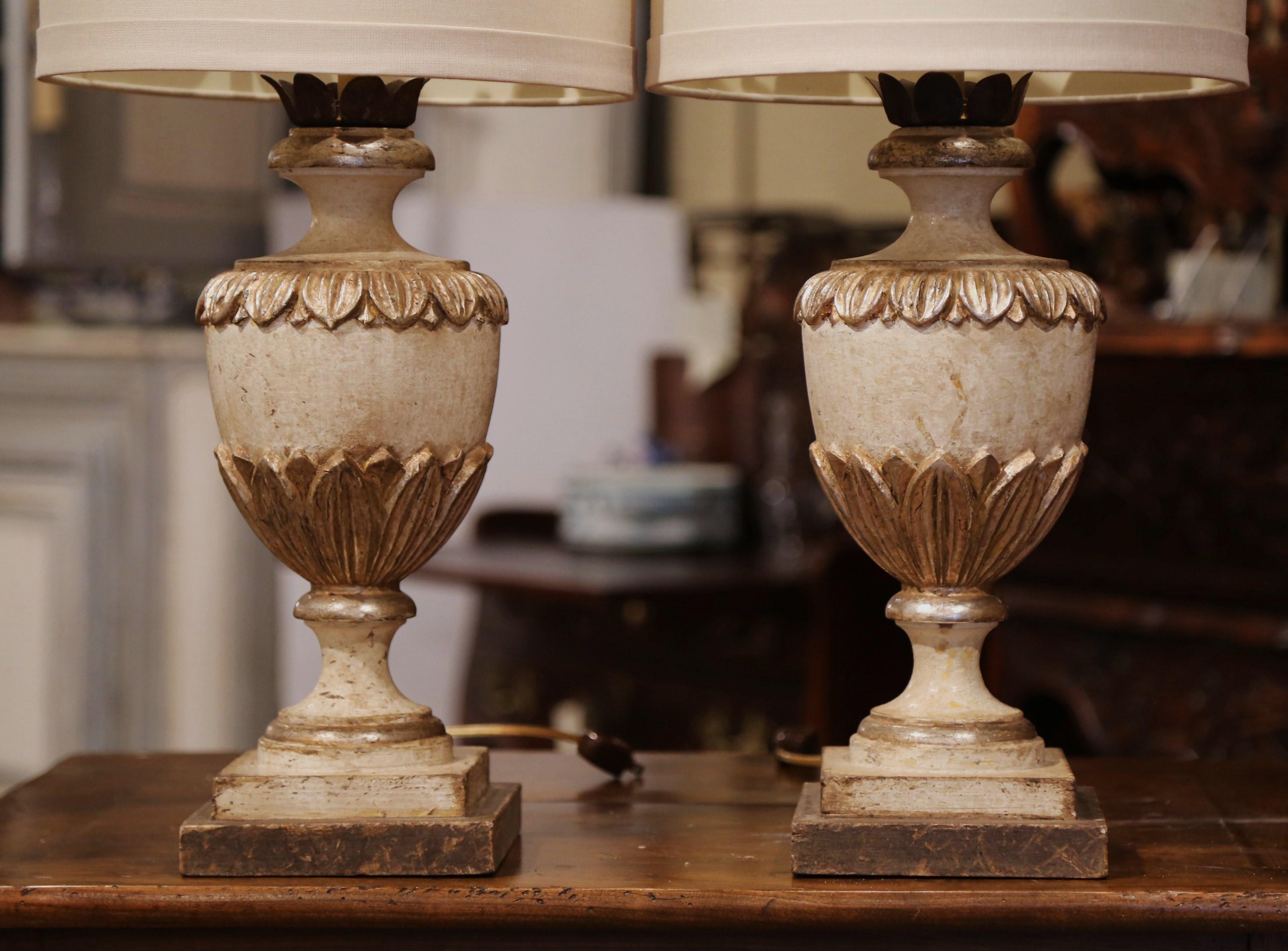 Incorporate extra light into a living room or bedroom with this elegant pair of hand-carved neoclassical lamp bases from Italy. The large, stately bases are in the shape of a traditional antique urn, embellished with carved acanthus leaf decor, and