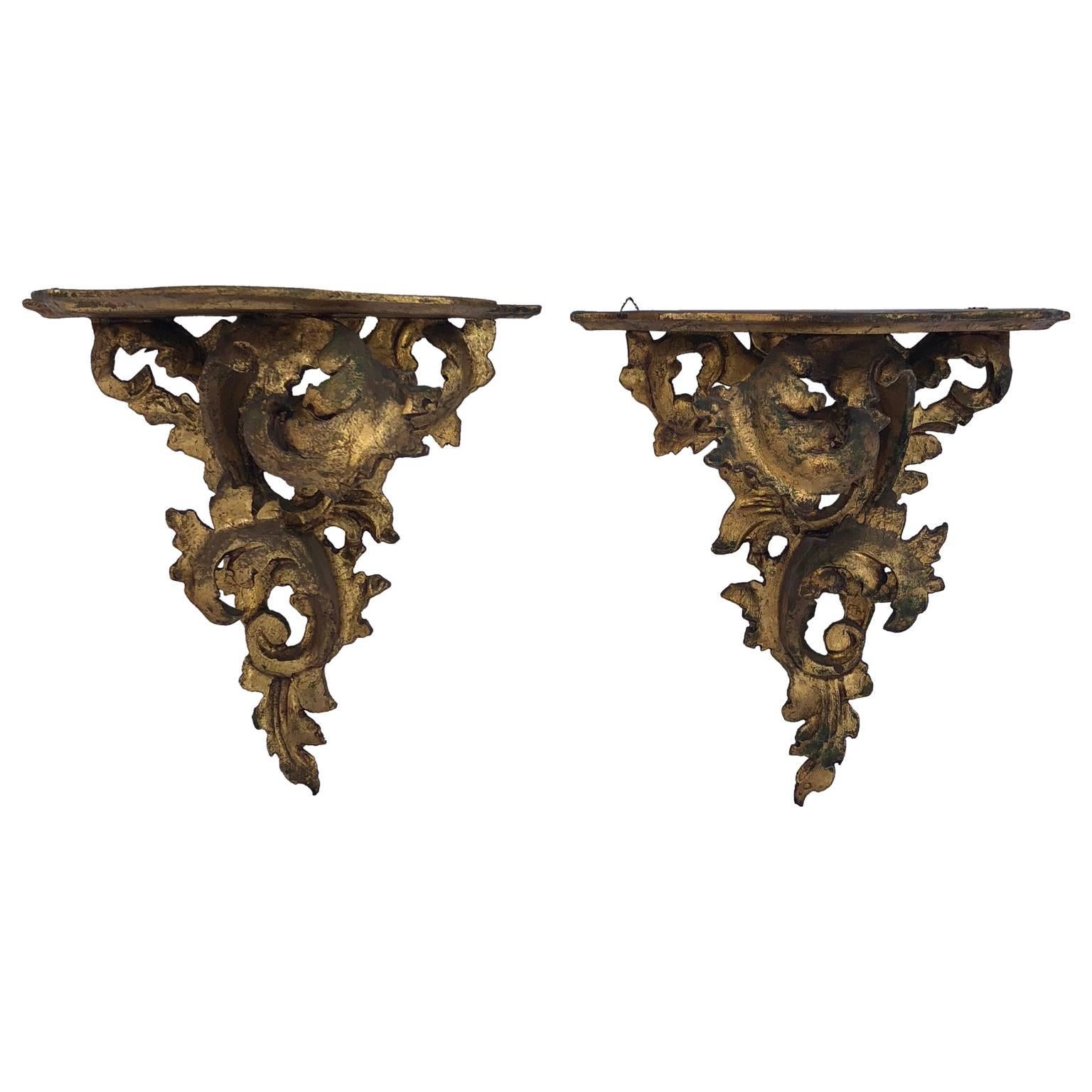 Pair of carved wood Rococo style wall mounted shelves.