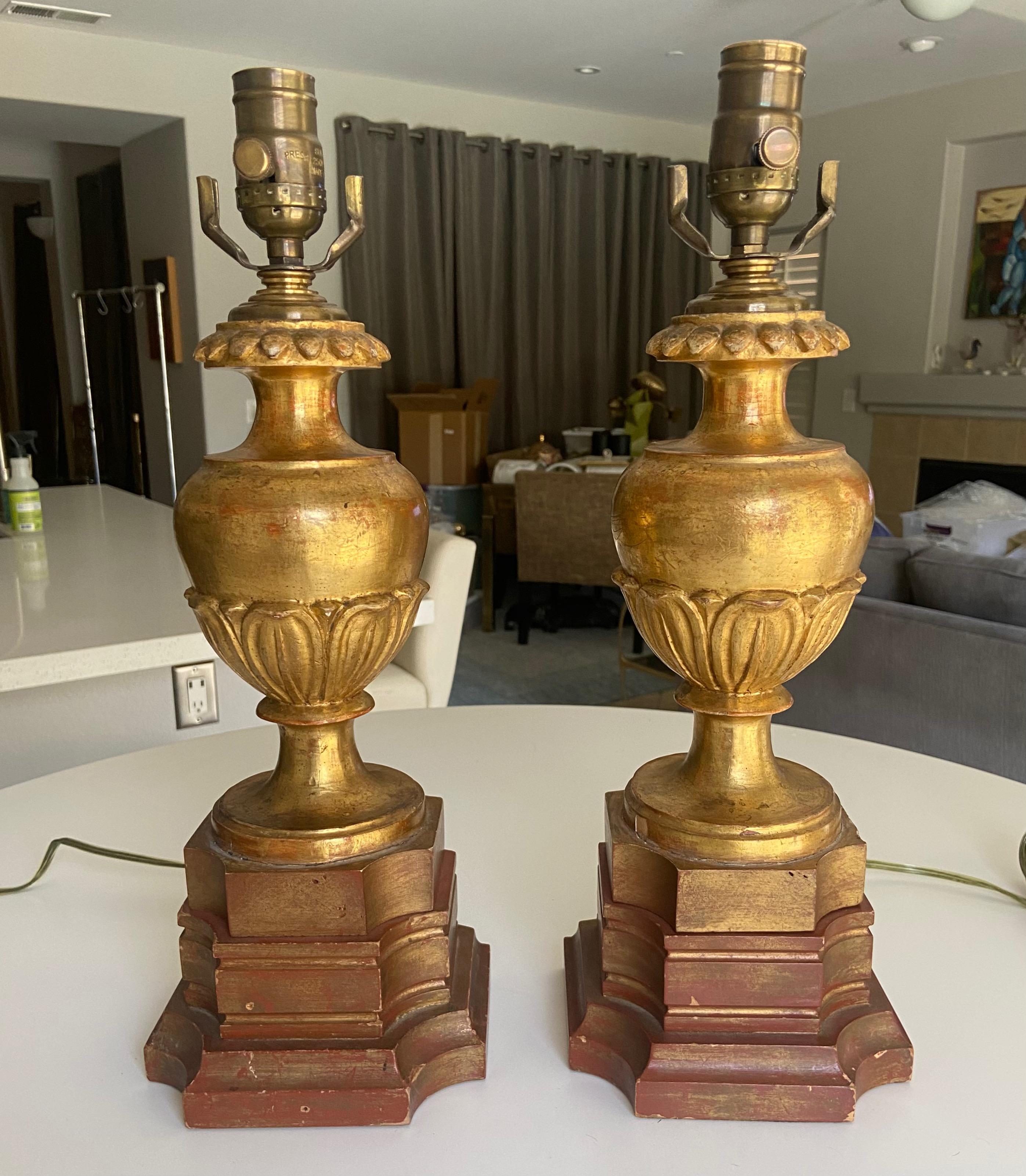 Pair of Italian water gilt carved wood candlesticks converted to lamps with later custom wood bases in a coordinating painted finish. Brass hardware fittings.