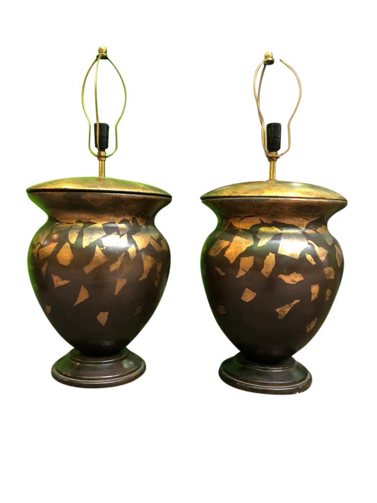 An absolutely stunning pair of Italian carved wooden lamps, 1920s. The lamps are decorated in a gold gilt pattern in the style of falling leafs. This pair are brilliant for home use, with a warm feel of comfort. Suitable for all interior design.