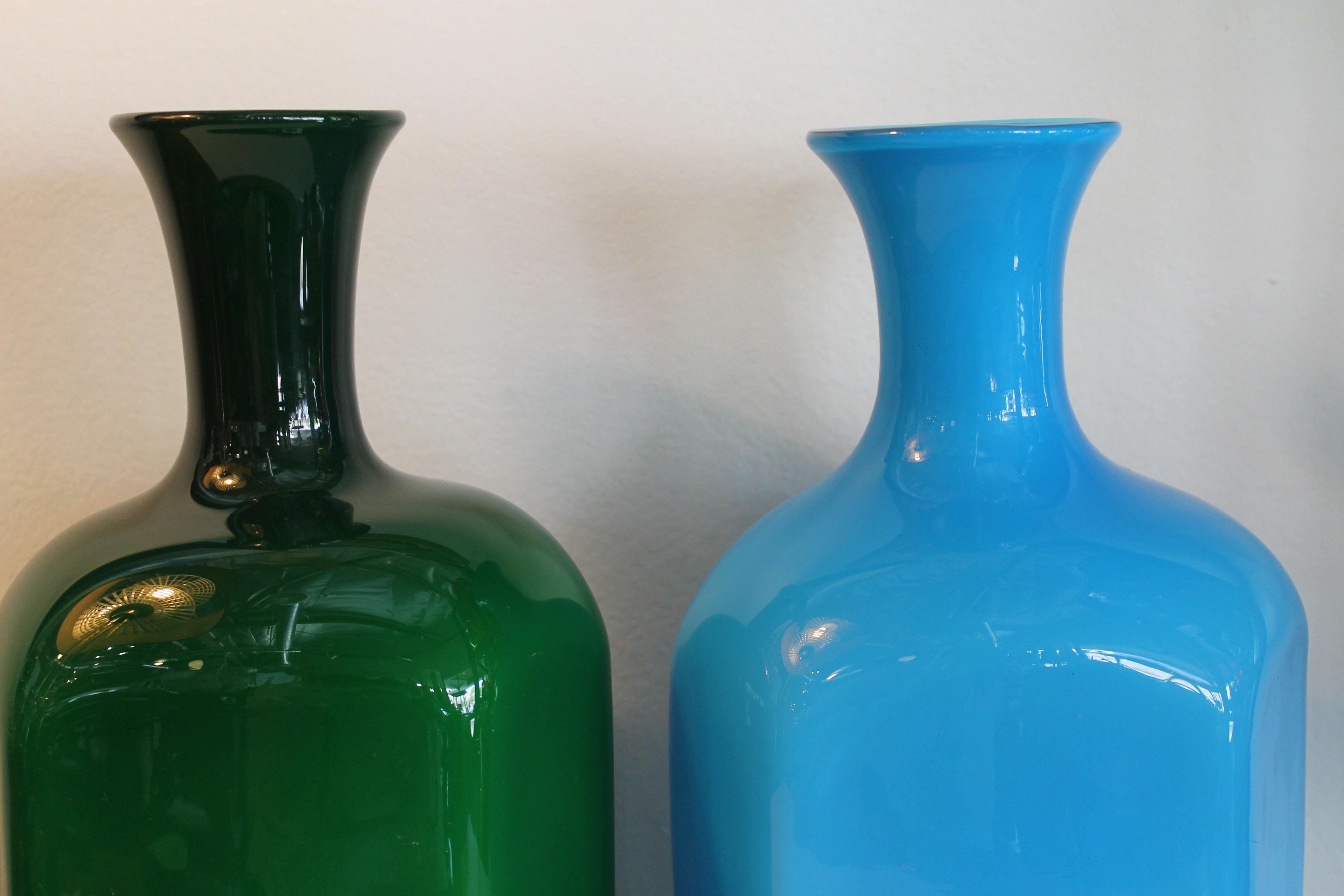 Pair of cased glass vases in blue and dark green. They each measure about 9