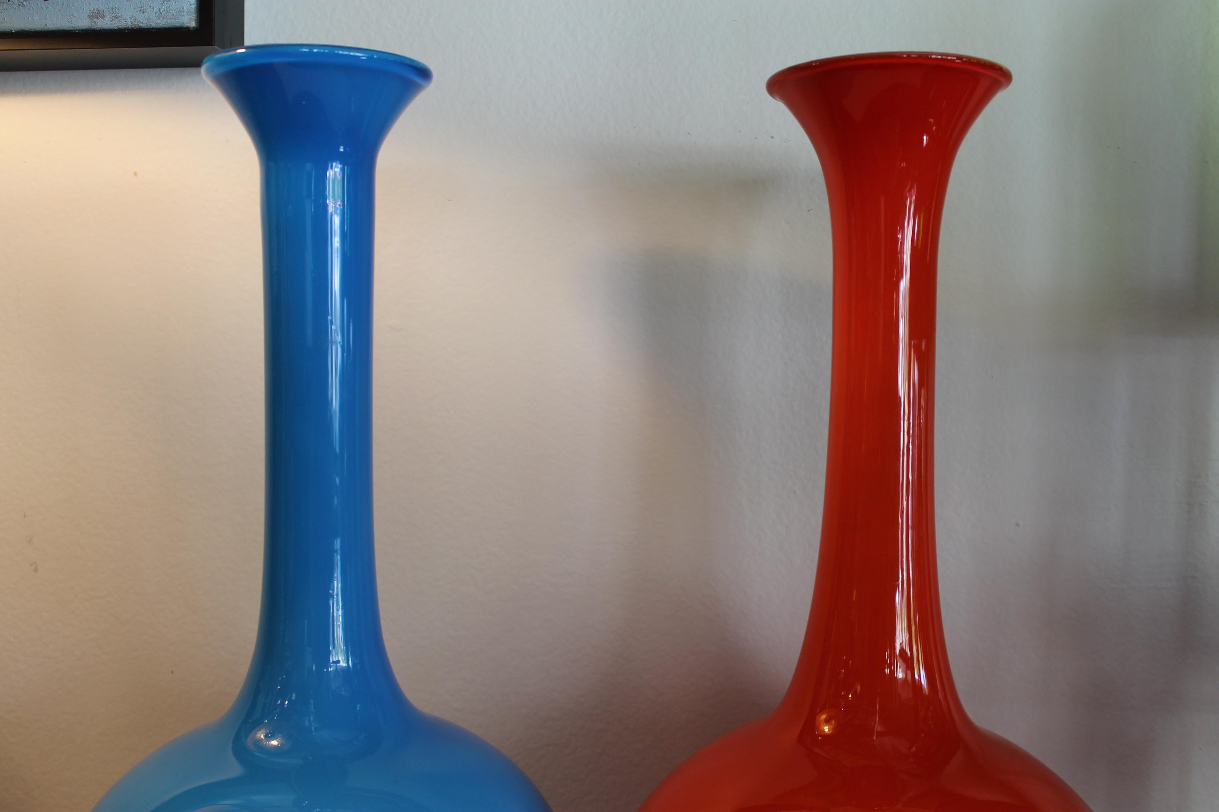 Monumental orange and blue Italian cased glass vases or decanters. They measure about 22.5