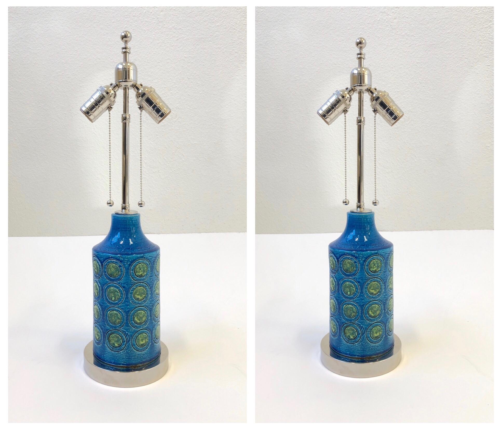 A beautiful pair of “Rimini Blue” table lamps designed by Bitossi in the 1960s. This lamps have been newly rewired with all new polished nickel hardware and new vanilla linen shades. 

Dimensions: 22.25” high, 16.25” diameter.