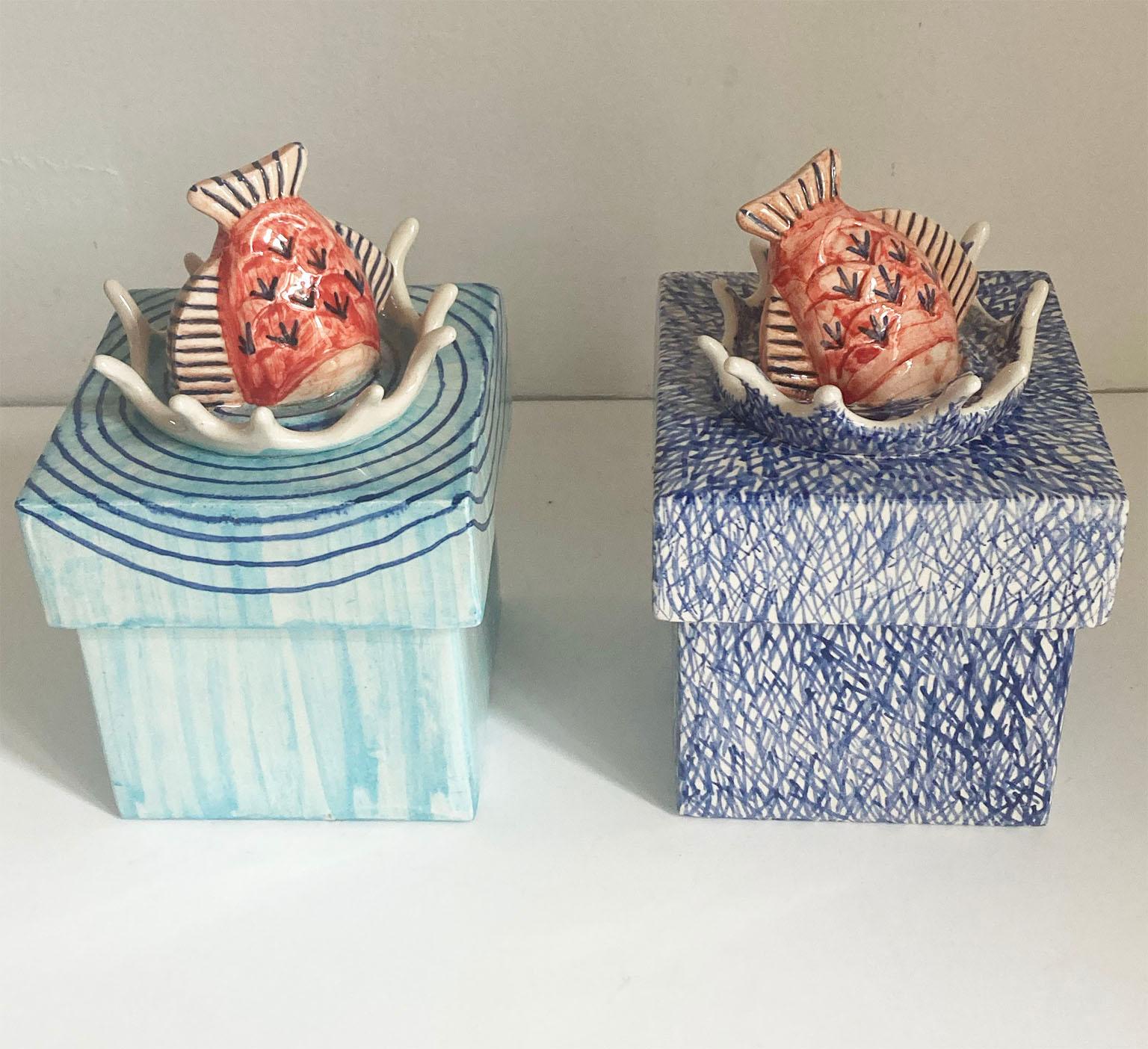 Pair of ceramic boxes with cubic shape; the cover has the fish ceramic insert.
 
  