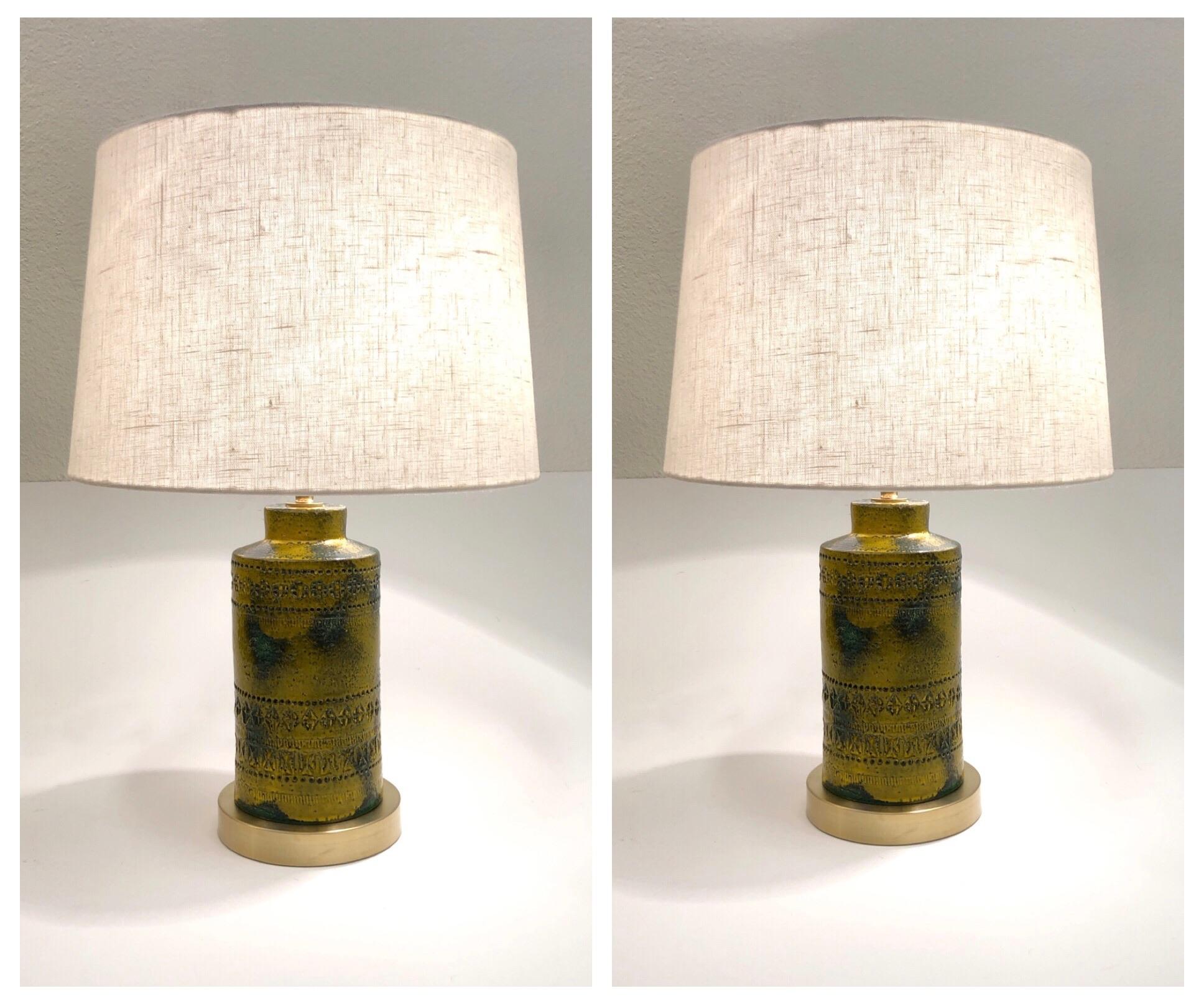 A beautiful mustard yellow and forests green ceramic table lamps designed by Bitossi in the 1970’s. 
Newly rewired with all new polish brass hardware, satin brass base and new vanilla linen shade. 
Dim: 15 diameter 21.75” high.
    