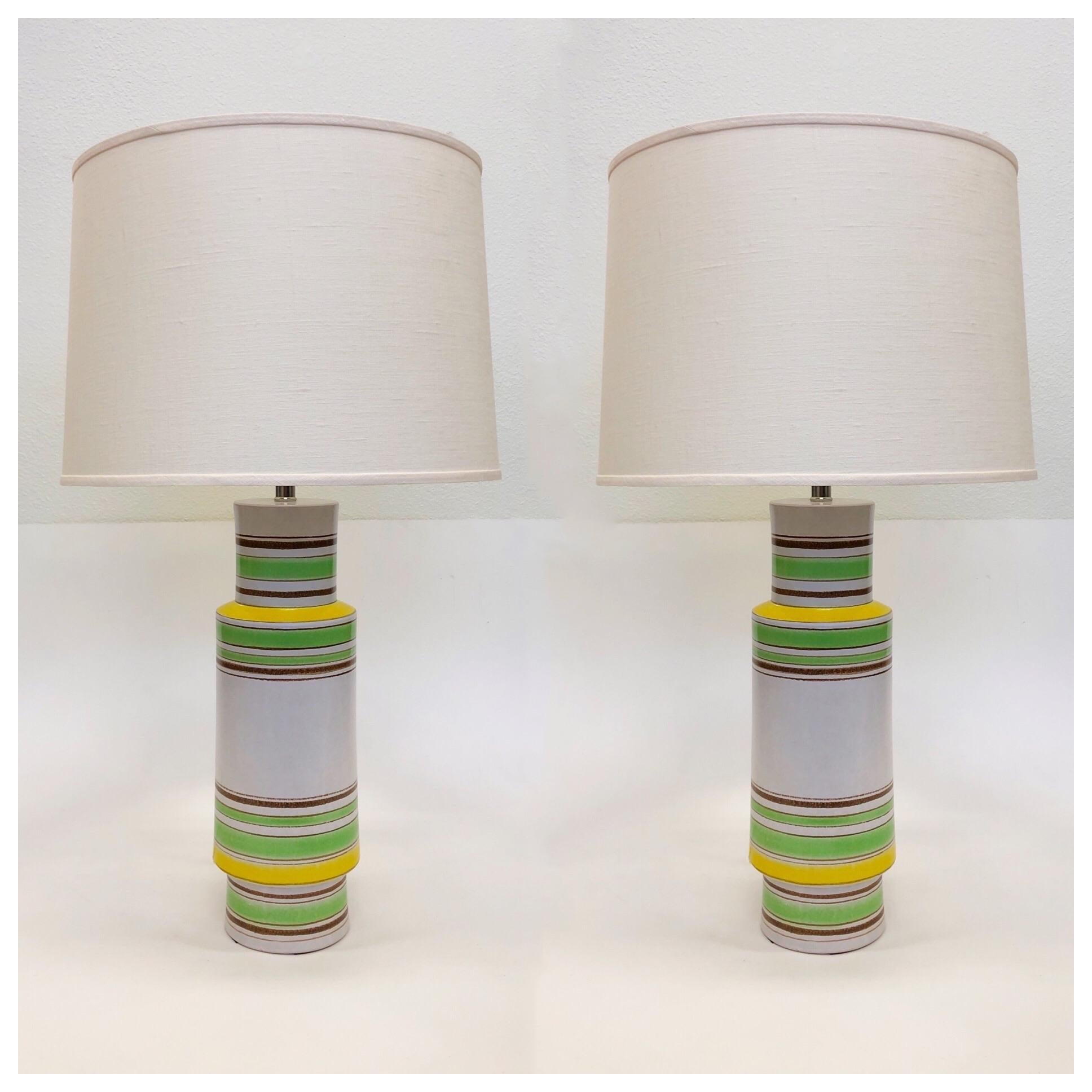 A beautiful pair of Italian ceramic table lamps designed by Bitossi in the 1970s
The lamps are ceramic with a white, lime green, yellow and brown glazed design. The lamps have been newly rewired with new polish nickel hardware and new vanilla linen