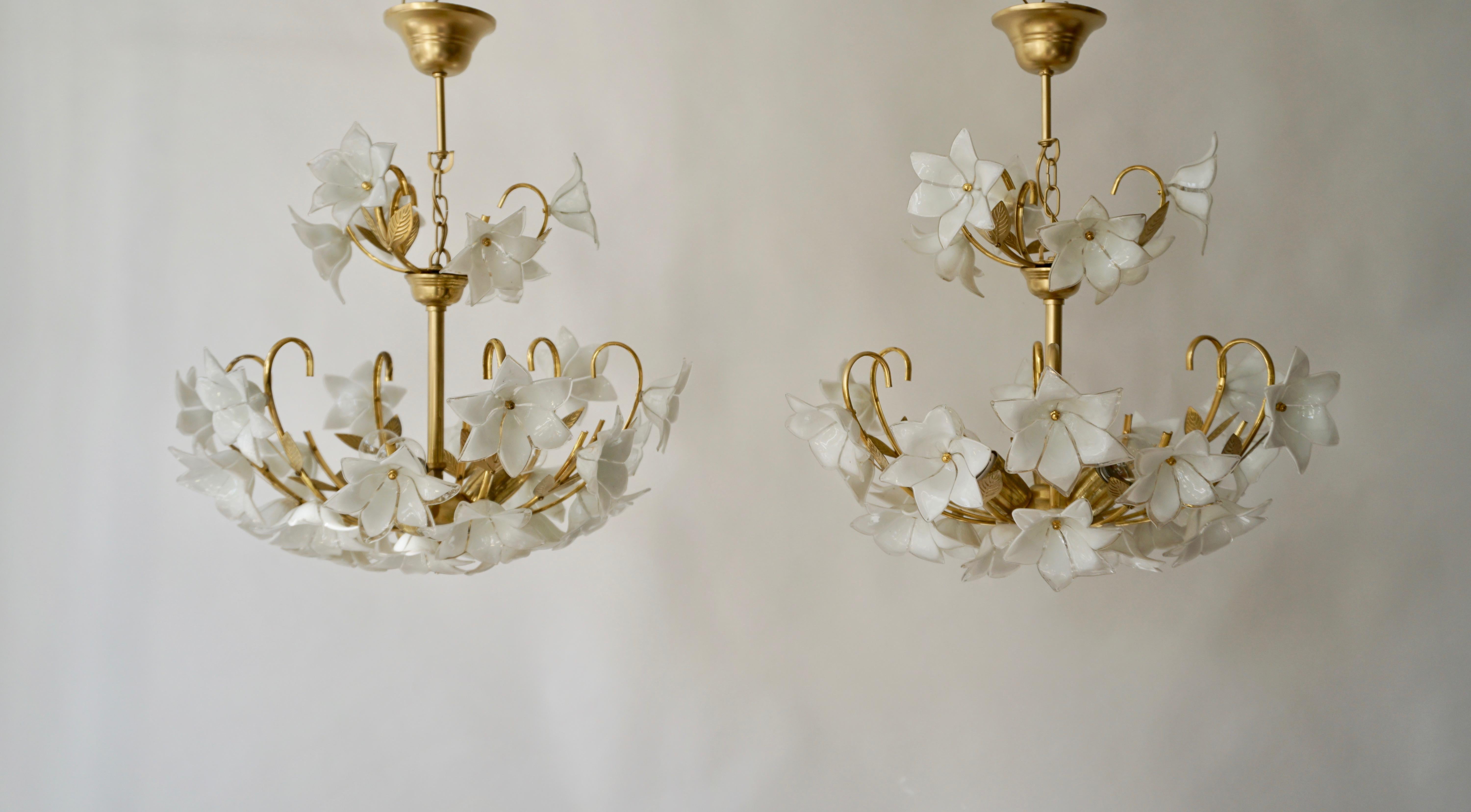 Two Italian chandeliers, 1970s Murano Art Glass chic and very particular, handmade flowers in Murano glass, a structure in brass and lacquered metal, truly unique and elegant in its kind.
Diameter 20.47 inch - 52 cm.
Height fixture 17.32 inch - 44