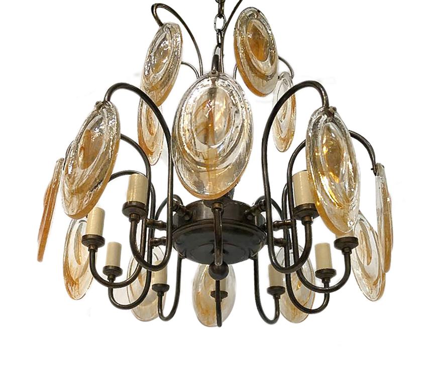 Pair of circa 1950s Italian patinated bronze chandeliers with molded glass pieces and with 10-light. Sold individually.

Measurements:
Height of body 18.5”
Diameter 19