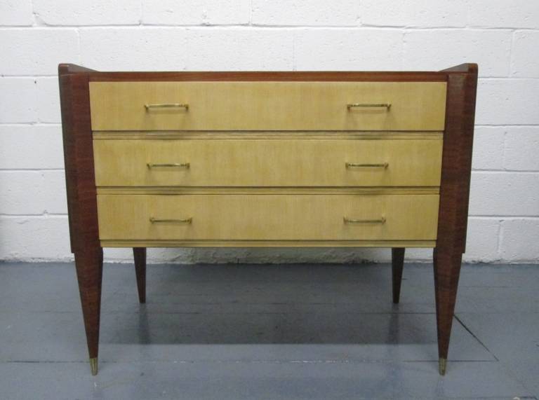 Pair of Italian chests in the manner of Gio Ponti. Has the original brass handles and brass sabots. Chest has three pull-out drawers.