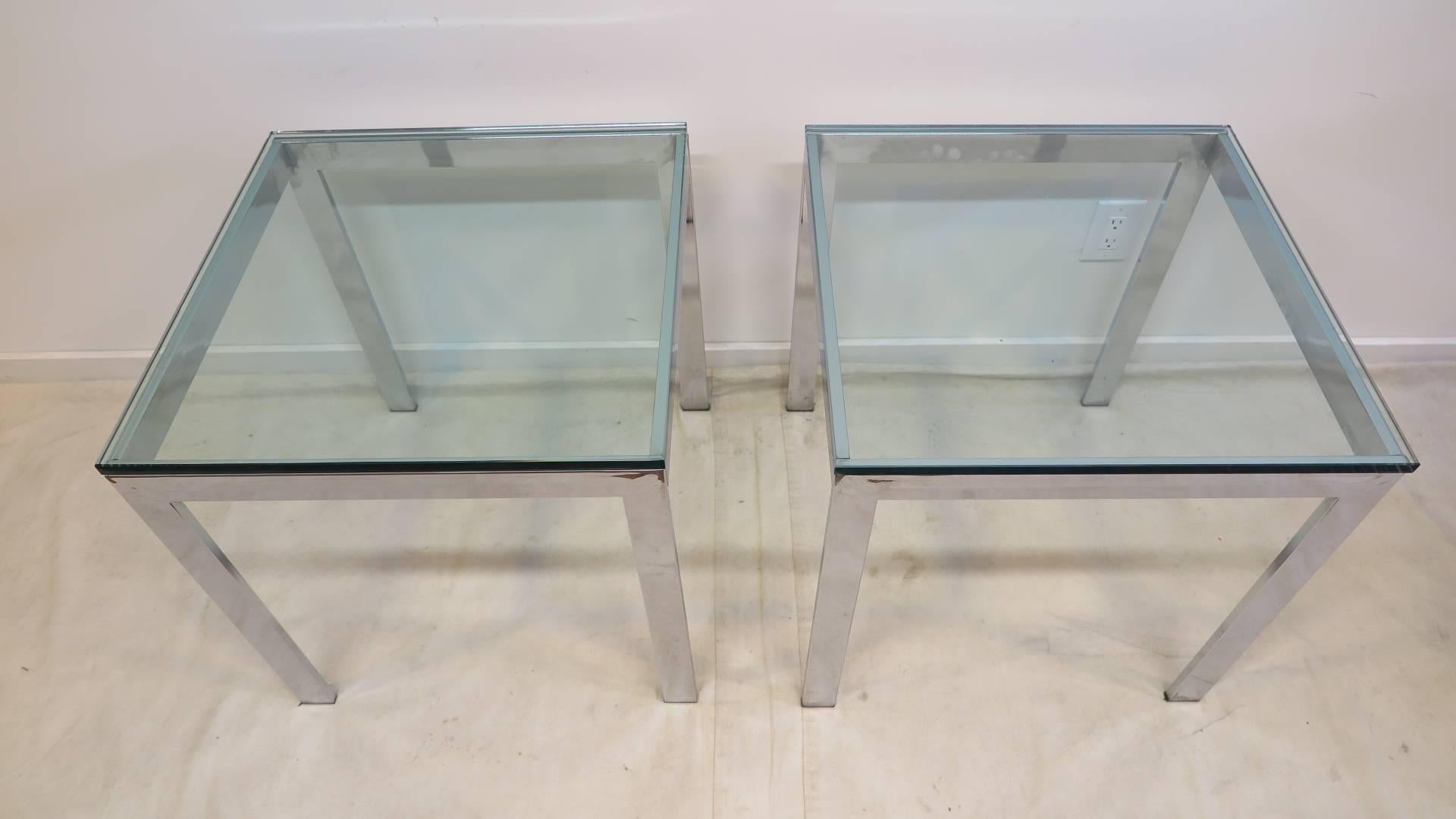 A pair of Italian chrome and glass side tables of very high quality. Striking legs with very thick glass 5/8 inch tops having polished bevelled edges. Excellent condition glass tops are very nice, original, very light use. From a NYC executive