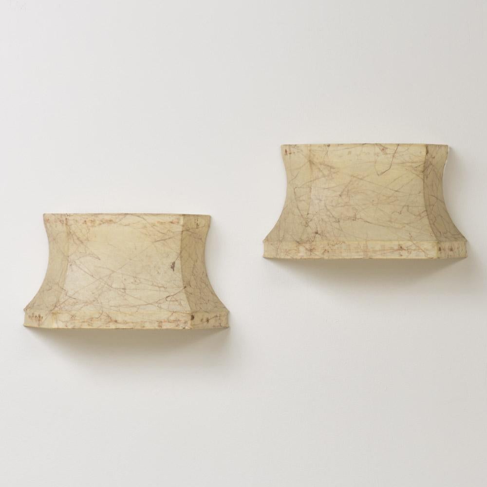Incredible cocoon sconces by Achille & Pier Giacomo Castiglioni from Italy, 1960's. Unique shade in a creamy parchment resin rests on original painted metal backplate. Original resin and backplate show nice age and patina. Newly rewired with two