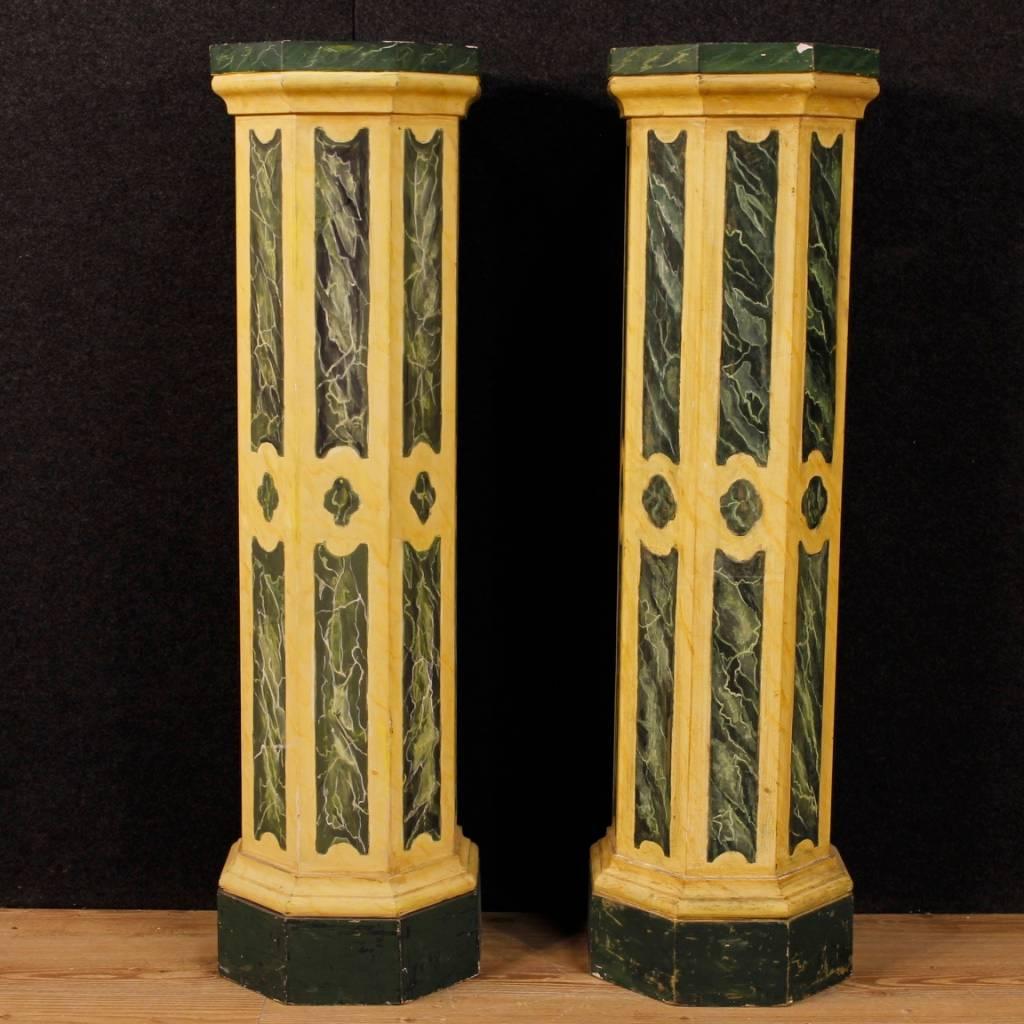 Pair of Italian columns from 20th century. Carved and lacquered faux marble wooden furniture of high quality. Octagonal columns with tops that show visible signs of wear and lack of lacquering to be restored. Solid structures ideal for displaying