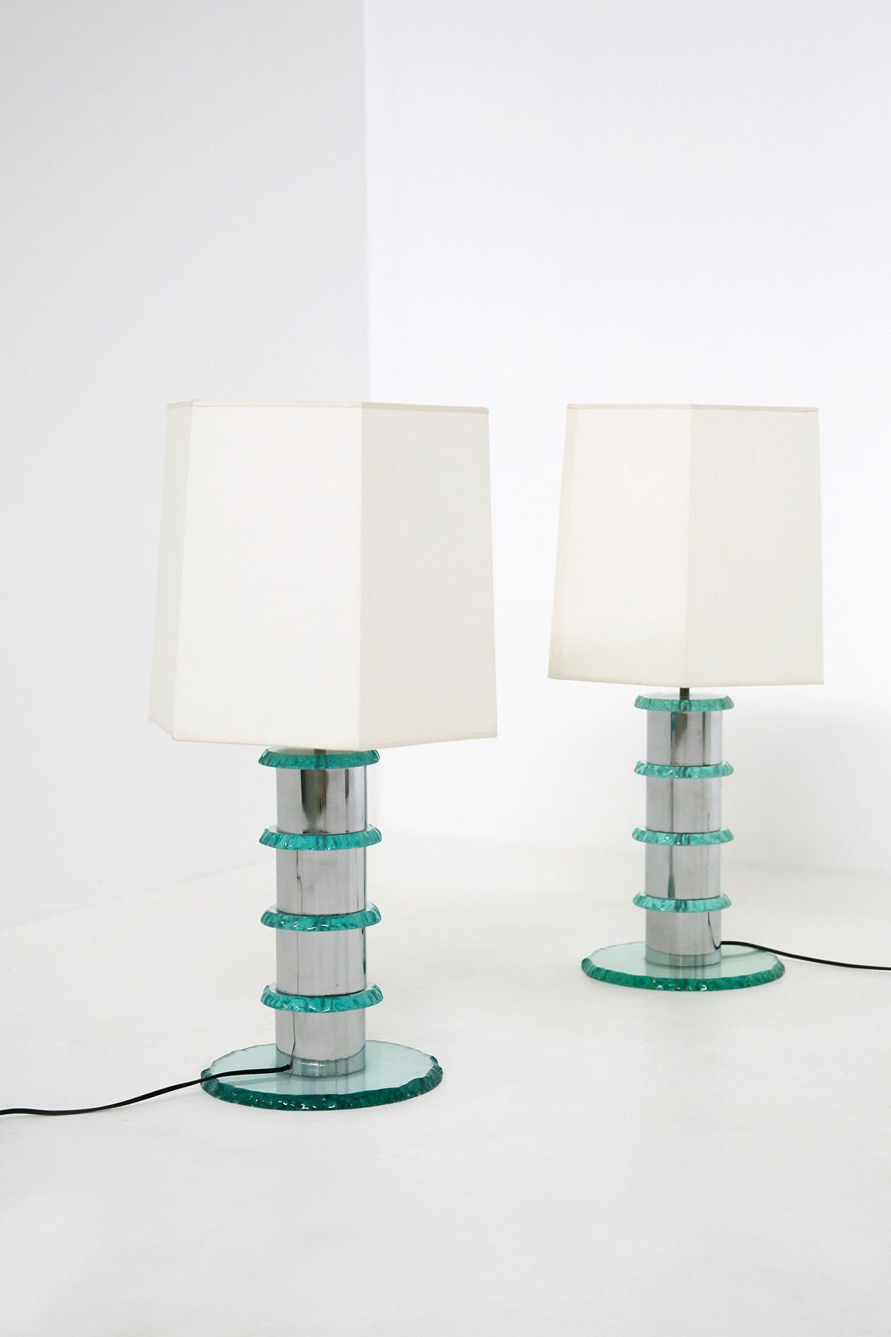 Elegant pair of contemporary Italian lamps. The lamps are made in Italy by master glassmakers. The lamp is handmade. The stem of the lamp is made of chrome plated steel and at each intersection we notice hammered glass circles applied. As a support