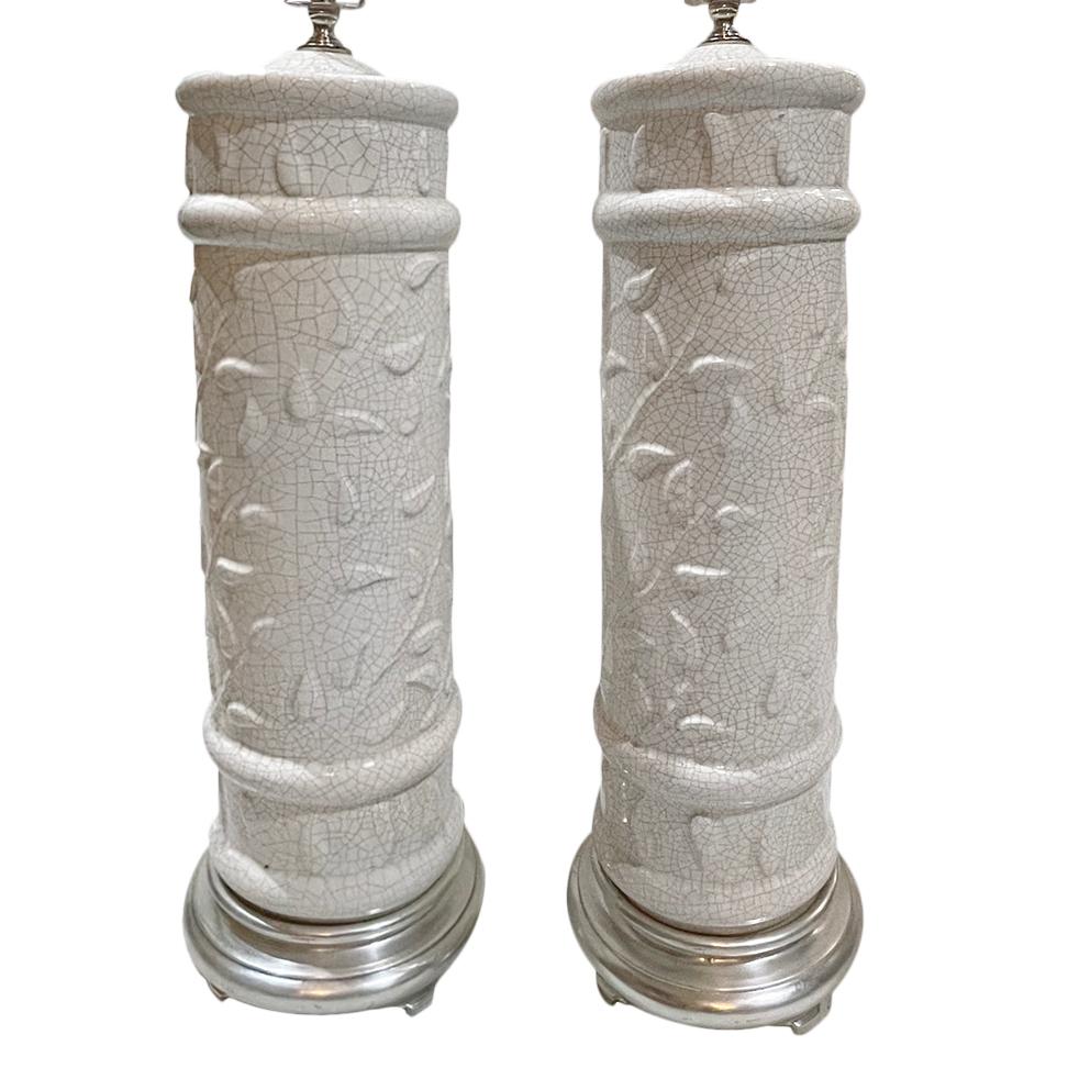 Pair of Italian circa 1950s white crackle glazed porcelain table lamps with silvered bases.

Measurements:
Height 23”
Diameter 8”.