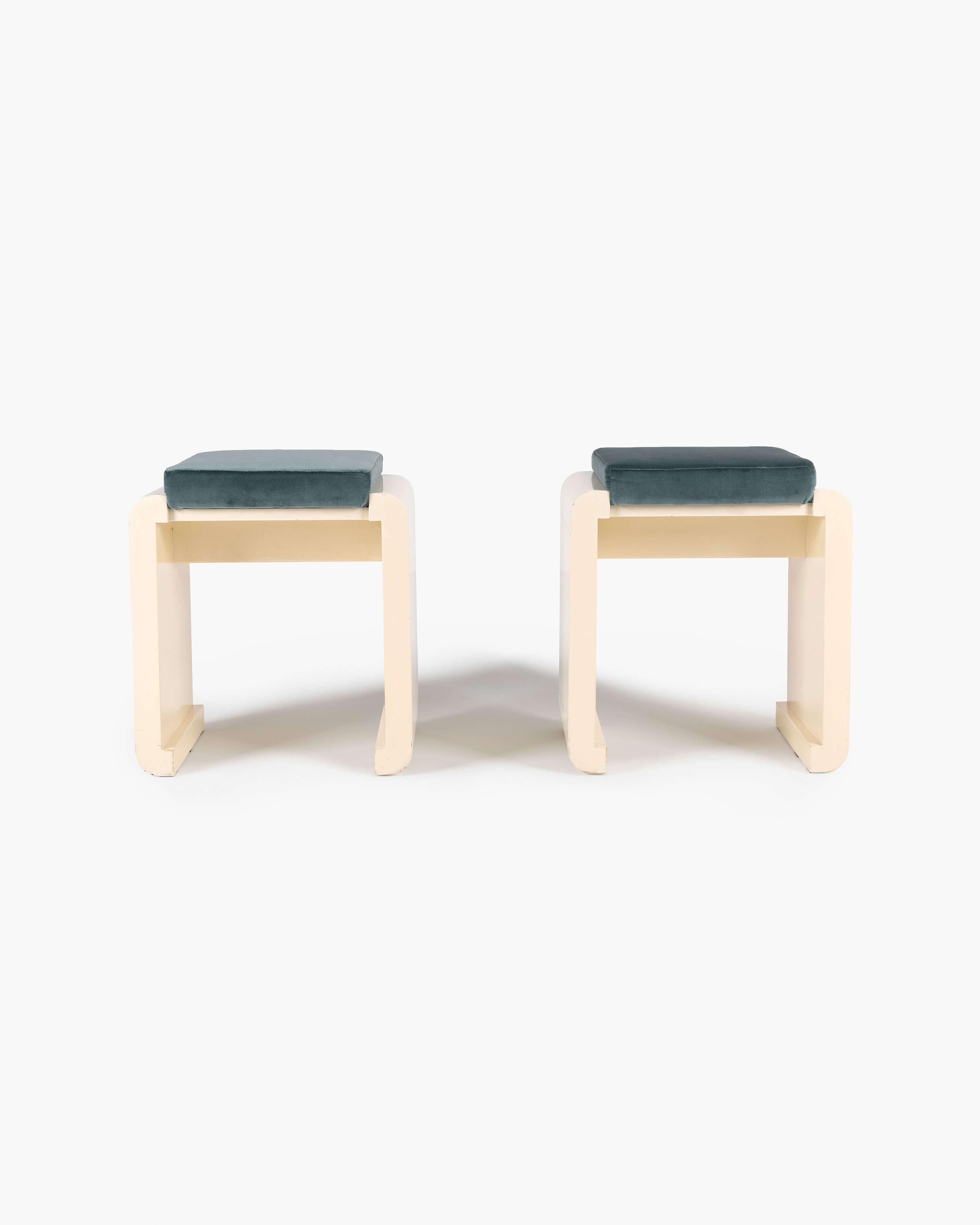 Pair of vanity stools ​​from 1970s Italy, uniting modernist lines with luxurious velvet upholstery. The gracefully rounded creme lacquered frame of this design supports a well-structured teal velvet cushion.