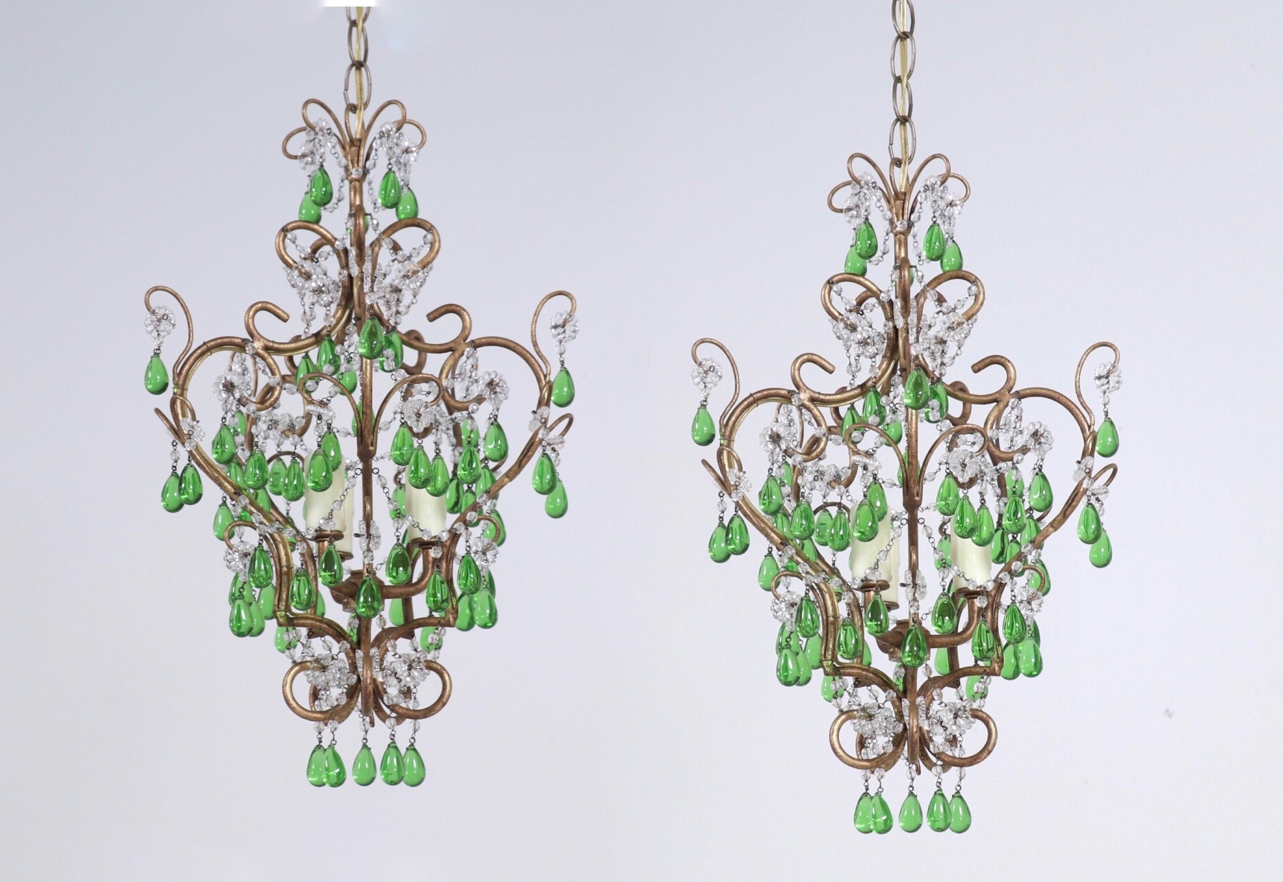 Exquisite, pair of petite vintage Italian gilt-iron and crystal beaded chandeliers.

Each chandelier consists of a scrolled and gilded iron frame which has been decorated with an abundance of green glass droplets. 

The chandeliers are wired and